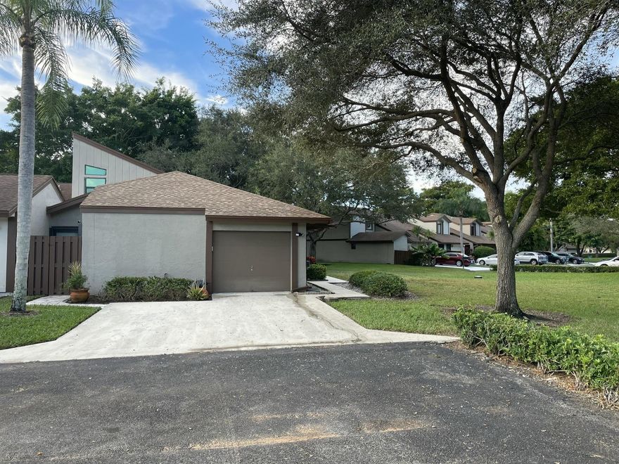Beautifully updated modern villa in highly desired Loggers Run. End unit with garage and loft. 1,600 sq. ft villa has 3 bedrooms plus a den/office and 2 full bathrooms. Villa has a 2024 roof, 2022 hurricane windows, 2025 hot water heater and 2022 appliances. Home has hurricane garage door and hurricane skylight, high gloss porcelain tile throughout including on the 300 sq ft covered/screened in patio. Tri-fold hurricane doors out to the patio for continuous living area. Separate storage located on the patio. Home has 2 tiled fenced in patios and a 1 car garage. Built in wall unit in living room and a crystal chandelier in dining area.Tax records show 1,455 sq ft base, 143 sq ft upper unfinished loft - total 1,598 sq ft under air