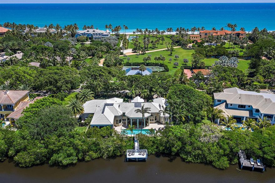 Location, location, location. Situated on a tranquil, tree-lined street, this waterfront retreat is a must-see. Featuring its own private lagoonside dock, this architectural gem is seconds to the sand and sea, via private community beach access, and moments from acclaimed golf, shops, and restaurants. Home features include a long stately motor court, soaring vaulted ceilings, airy open-plan interiors, a 40-foot pool, and a screened-in porch ideal for poolside, sunset dining. Should more space is required you could add a second floor or an addition/guest house on the north side of the property.