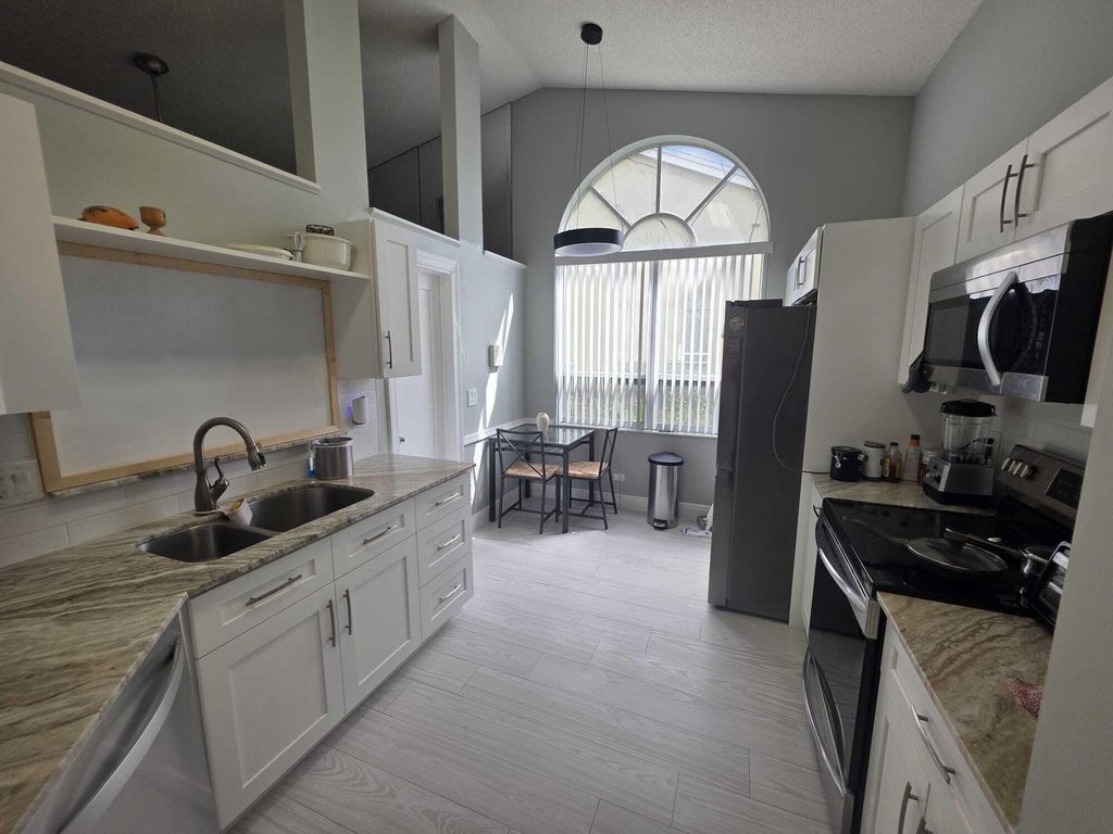 Photo of 6201 Pond Tree Court, Greenacres, FL 33463 (MLS # B26026459)