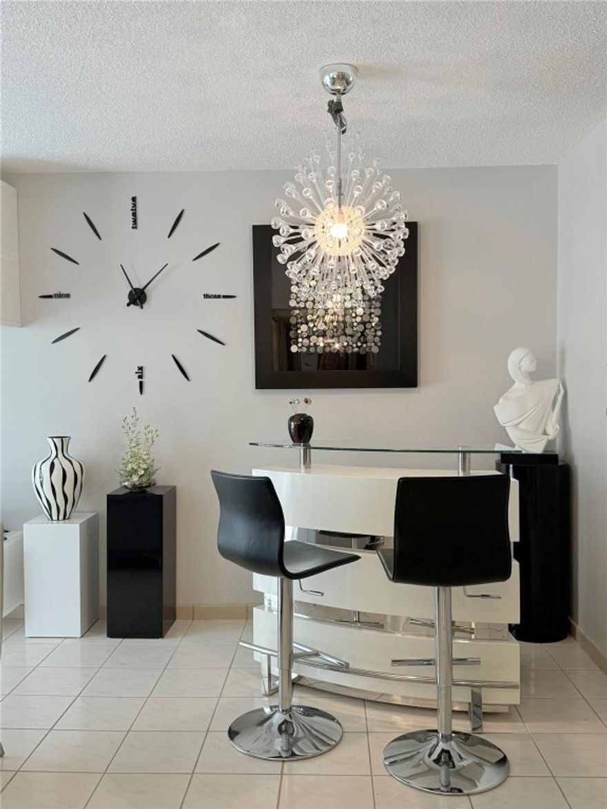 Bright and stylish 2/2 CORNER-unit condo on the 3rd floor! This beautifully furnished home features an OPEN MODERN KITCHEN with white cabinets, GREY QUARTZ countertops, and a chic coin-style bar. Both bathrooms are FULLY RENOVATED, including a STUNNING blue-and-gold tiled masterpiece. IMPACT WINDOWS & DOORS throughout offer peace of mind. Enjoy a serene LAKE VIEW from the dining area and relax in the spacious master bedroom with a king-size bed. MOVE-IN READY and decorated with exceptional taste!55+ community w/pools, bbq area, shuffleboard, billard, fitness. Minutes away from restaurants, shops, & beautiful beaches.