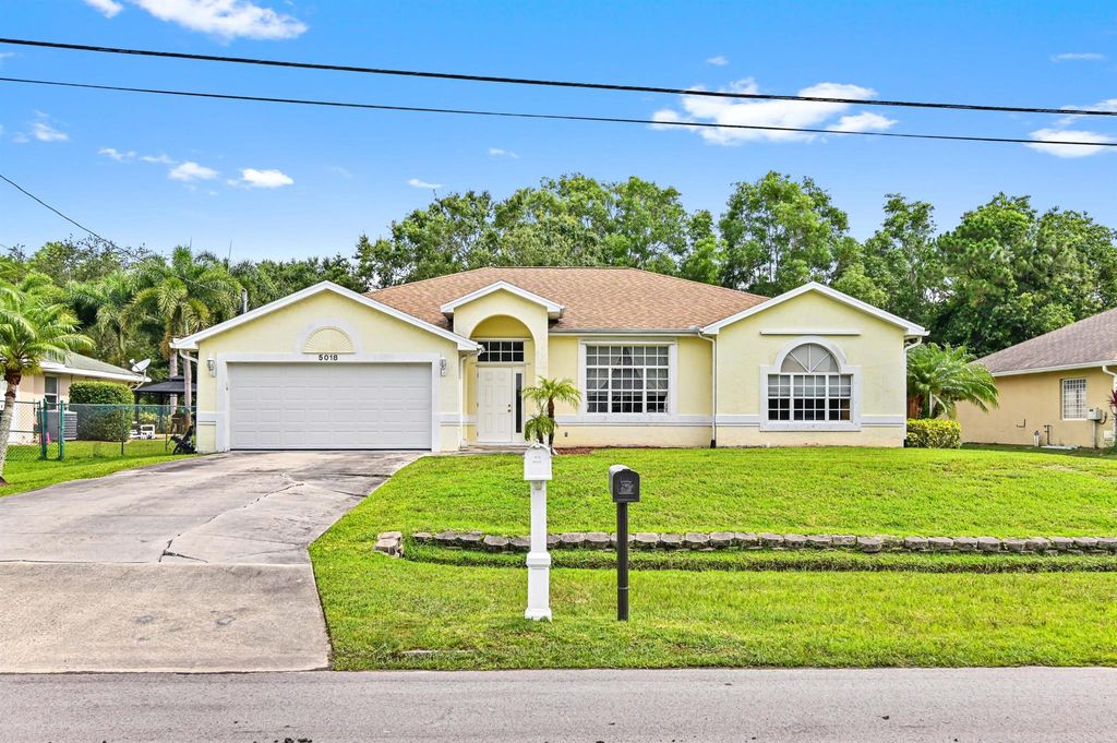 Photo of 5018 NW Flintstone Avenue, Port St Lucie, FL 34983 (MLS # R10897777)