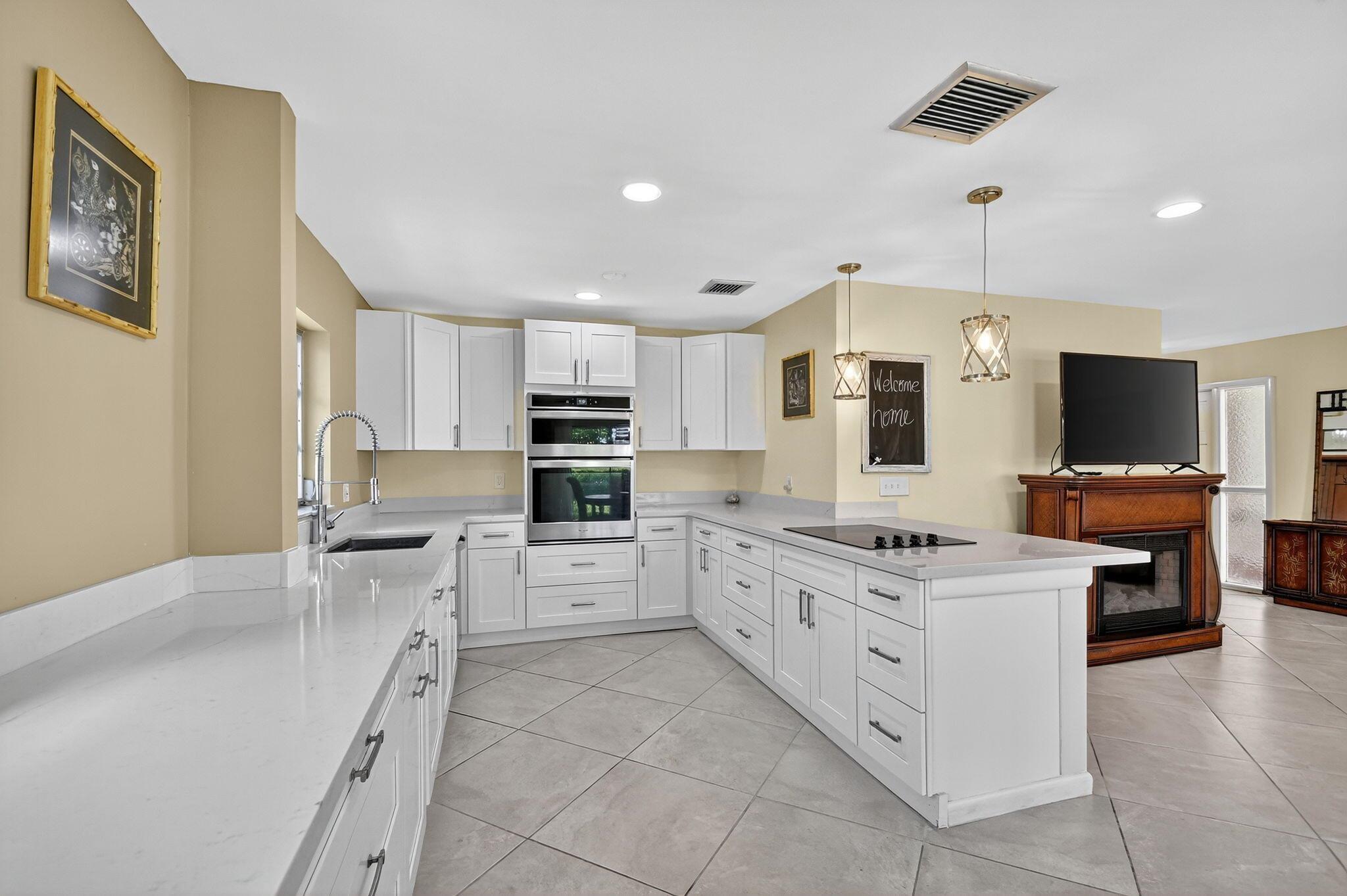 Nestled within the exclusive, fully gated enclave of Atlantis, this first-floor unit offers exceptional value and sophistication. With a long-standing, budget-friendly HOA and an open-concept design, living here blends ease, style, and endless possibilities.This unit offers an open-concept floor plan, and an ideal northern exposure--providing soft, indirect sunlight and enhanced energy efficiency year-round. Overlooking one of Atlantis's pristine golf courses, the views are as peaceful as they are picturesque.Updated to modern standards this unit was designed with function and flow in mind. Whether you're hosting an intimate gathering or enjoying quiet mornings with coffee, the space delivers effortless comfort, blending indoor and outdoor living.