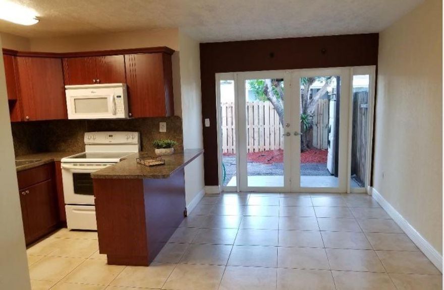 Updated corner unit ready for its next tenant! Located near I-595, BCC, Nova, and FAU campuses, it’s perfect for students, roommates. A closet under the stairs is set up as a server room. Flooring includes tile downstairs and. Bedrooms are spacious with deep closets, and bathrooms have been updated with modern vessel sinks. There’s also an outdoor utility closet with washer/dryer hookups.