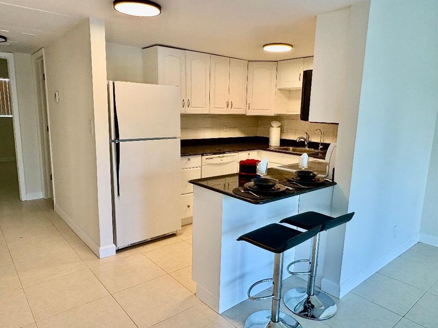 Experience effortless coastal living in this beautifully positioned corner residence just moments from the iconic Deerfield Beach Pier. This cozy 1-bedroom, 1-bath condo offers a seamless blend of modern upgrades and relaxed beachside charm, featuring a newly renovated bathroom, impact windows and doors, and sun-drenched interiors.  Designed for both comfort and style, the open living space invites natural light throughout, creating a serene retreat just steps from the sand. Indulge in the ultimate South Florida lifestyle with fine waterfront dining, boutique shopping, and oceanfront strolls all within walking distance.  An exceptional opportunity for a primary residence, seasonal escape, or income-producing investment with immediate rental flexibility.