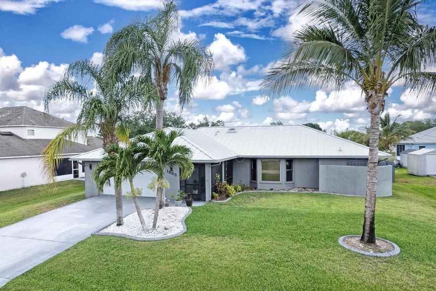 Best market value!!! Low cost living with no HOA and lower insurance cost due to new metal roof and CBS construction!!! This elegantly renovated CBS construction home offers 1,888 sq ft of refined interior space and 2,898 sq ft outdoors. Featuring 3 bedrooms, 2 bathrooms, and a 2-car garage, it boasts a 2024 metal roof, 2022 tankless water heater, newer A/C, and full stainless-steel appliance package. The spacious eat-in kitchen includes a pass-thru window, while the expansive screened lanai opens from both the master and guest suites. The luxurious primary suite offers a dual-head shower, spacious walk-in closet, and private lanai access. Laundry room includes washer, dryer, and tub. High-end ceiling fans throughout. Fully fenced yard in a prime, convenient location. Priced firm to sell!