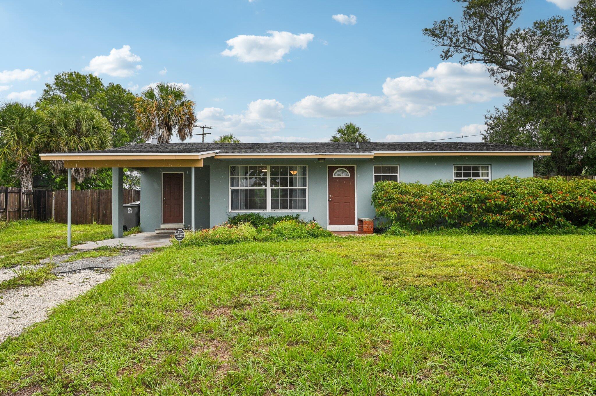Bring your boat, RV and all your toys- this 3 bedroom, 2 bathroom house is on a third of an acre in unincorporated Palm Beach County! No HOA restrictions. This comfortable home comes complete with a carport, newer screened patio, new refrigerator, 2023 AC, tile floors, storage shed and oversized fenced backyard with a double gate and ample room for a pool, all situated along a canal. This is the opportunity you've been waiting for!