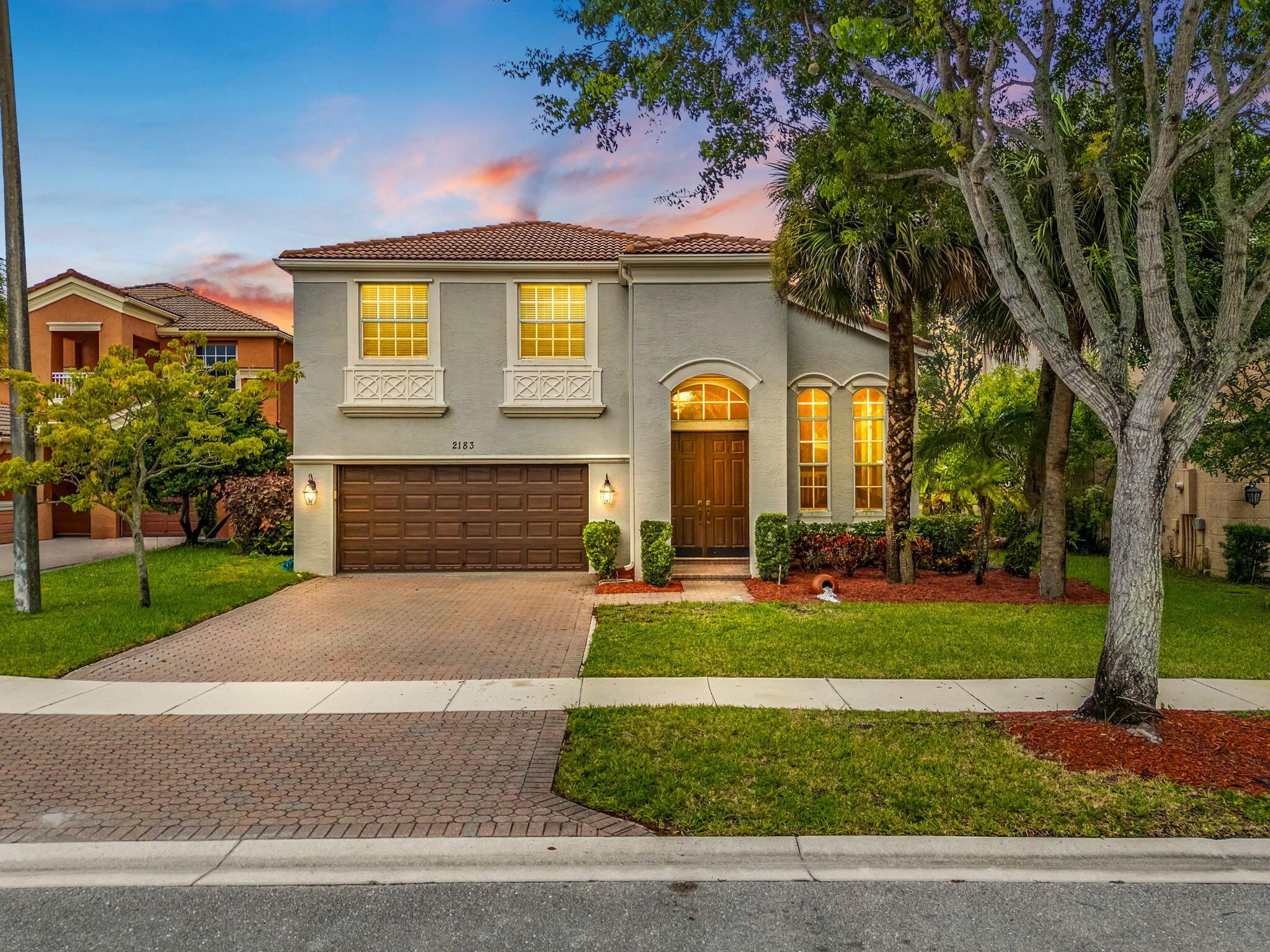 Welcome to this beautiful Mediterranean-style home located in the highly sought-after gated community of Olympia in Wellington. Built in 2003, this two-story residence offers nearly 2,800 square feet of comfortable living space with four bedrooms and three full bathrooms, including a spacious upstairs master suite and a first-floor guest room that can easily serve as a private office. The home's thoughtful floor plan features a formal living room, dining room, family room, and an open kitchen with ample space for both entertaining and everyday living. Upstairs, the oversized master retreat provides a peaceful escape, while additional bedrooms are generously sized. The home sits on a beautifully landscaped .16 acre waterfront lot and offers tranquil lake views.