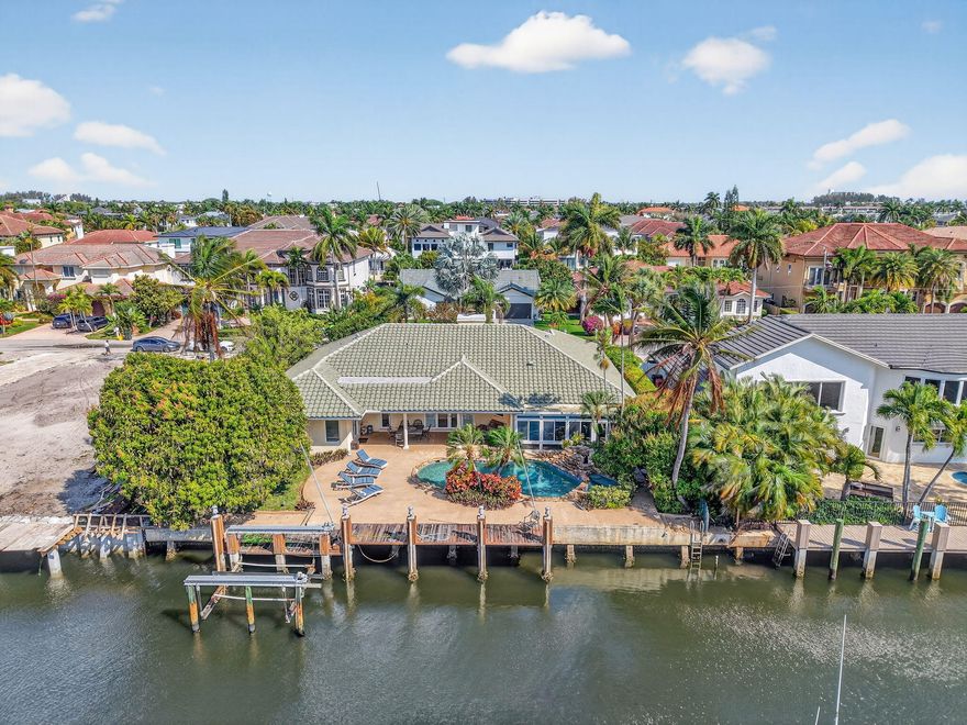 Located in the highly desirable boating community of Tropic Isle in East Delray Beach, this exceptional waterfront property presents a rare opportunity for both developers and end-users alike. Offering 90 feet of deepwater frontage with a private dock, no fixed bridges, and direct ocean access, this property is ideal for those seeking the ultimate South Florida waterfront lifestyle or the perfect site for new construction.  This 3-bedroom, 2-bathroom pool home spans 2,923sqft and features a spacious layout with vaulted ceilings, a double-sided fireplace, and an abundance of natural light throughout. The home also includes an air-conditioned sunroom.  The backyard offers a private setting with a pool and expansive waterfront views, an ideal canvas to renovate, reimagine, or build a custom luxury estate. Positioned on a prime lot in one of East Delray's most sought-after waterfront communities, this is a rare chance to create a truly exceptional residence Just minutes from downtown Delray Beach, world-class dining, shopping, and pristine beaches, this home combines luxury, convenience, and the ultimate South Florida lifestyle.