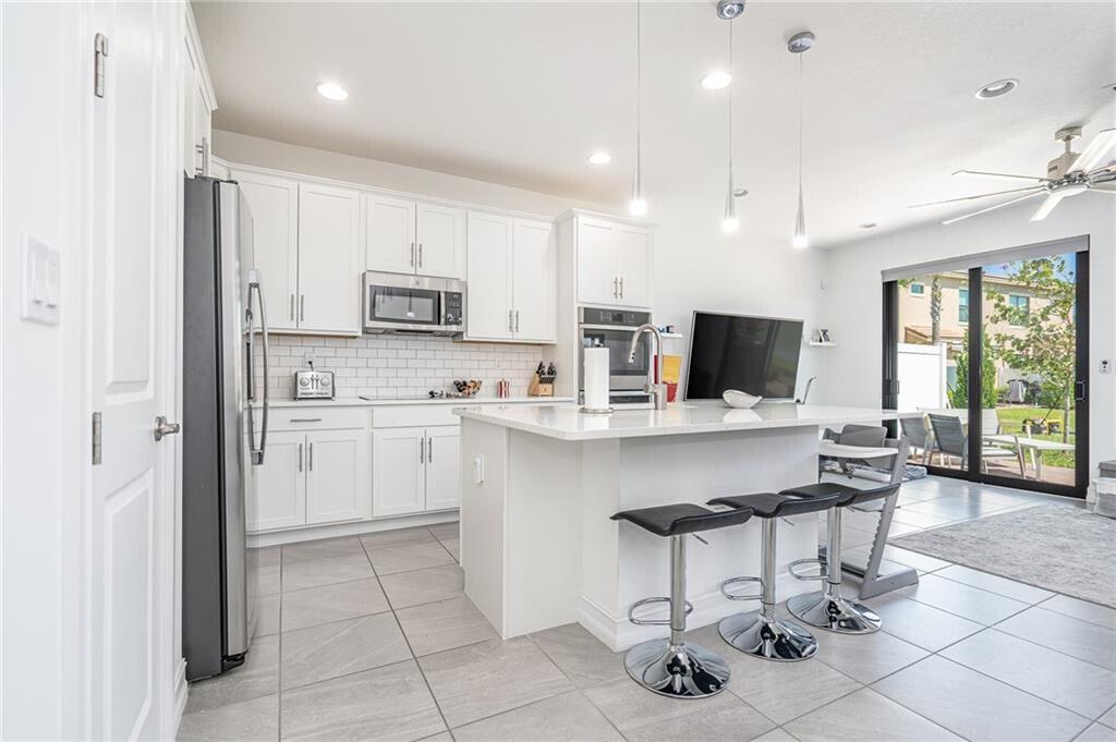 Modern townhouse located in the desirable gated Boca Raton community of Enclave. Featuring 3 beds & 2.5 baths this townhouse features a gorgeous chefs kitchen w/ white shaker cabinets, quartz countertops & stainless steel appliances. The open floor plan w/ volume ceilings is perfect for entertaining family & friends. The large owner's suite offers a custom walk-in closet & on-suite bath w/ oversized frameless shower. This home comes loaded w/ designer features, custom light fixtures, fans & recessed lights throughout the house. The convenient 2nd floor laundry room also has a wash sink & extra storage. Full hurricane protection w/ impact glass throughout. Community amenities include clubhouse, fitness center, pool & Spa.