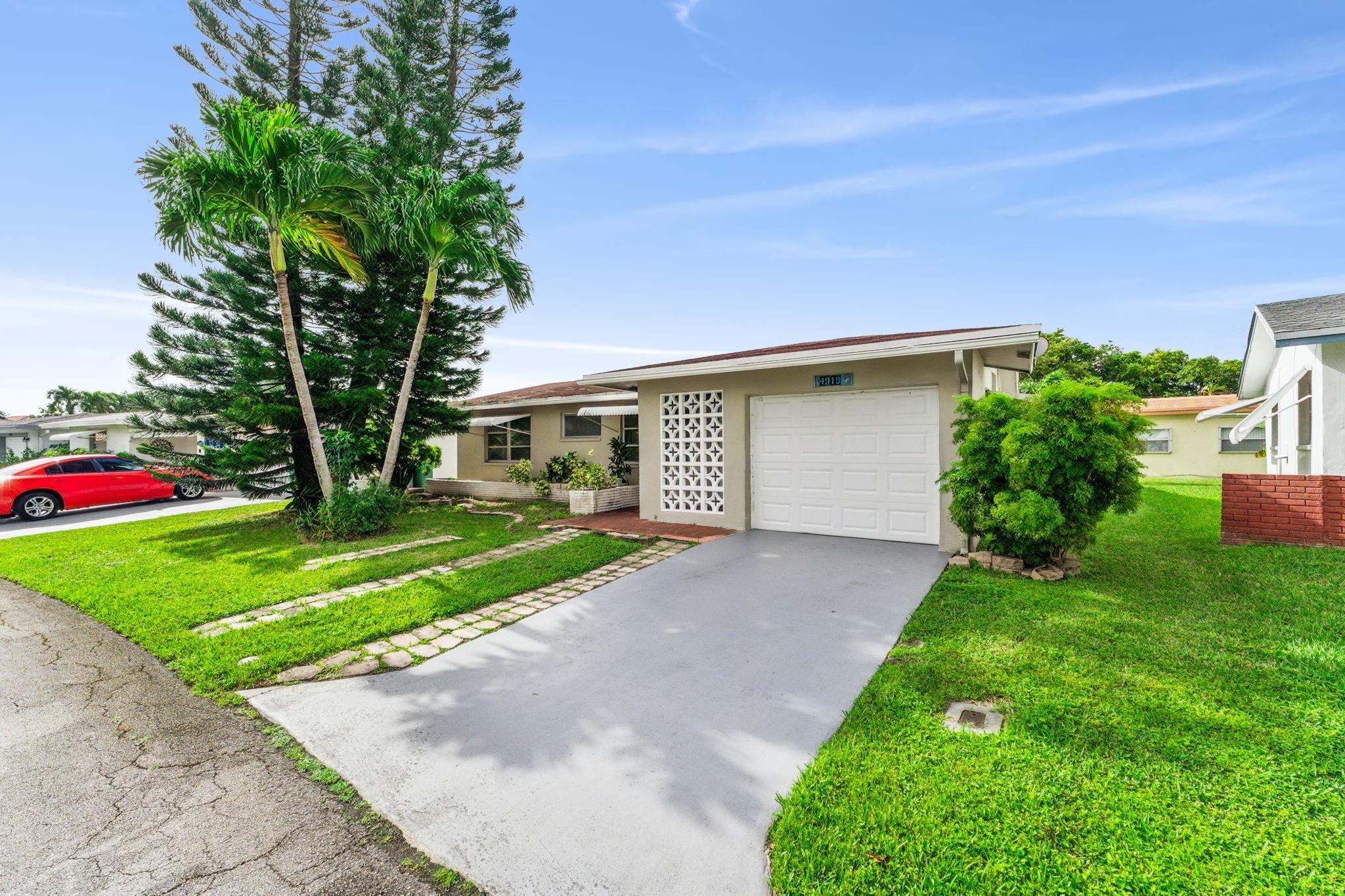Welcome to this beautifully updated single-family home located in the desirable Mainlands of Tamarac, a vibrant 55+ community! This charming residence features 2 spacious bedrooms, 2 modernized bathrooms, and a 1-car garage. Enjoy relaxing mornings or peaceful evenings on your private screened-in porch. Freshly painted throughout, the home boasts a brand-new kitchen complete with stylish cabinetry and new appliances — move-in ready for its next owner. The community offers fantastic amenities, including a sparkling pool, BBQ areas, and a clubhouse, all conveniently close to shopping, dining, and major highways for easy commuting. Don’t miss the opportunity to enjoy the Florida lifestyle at its finest!