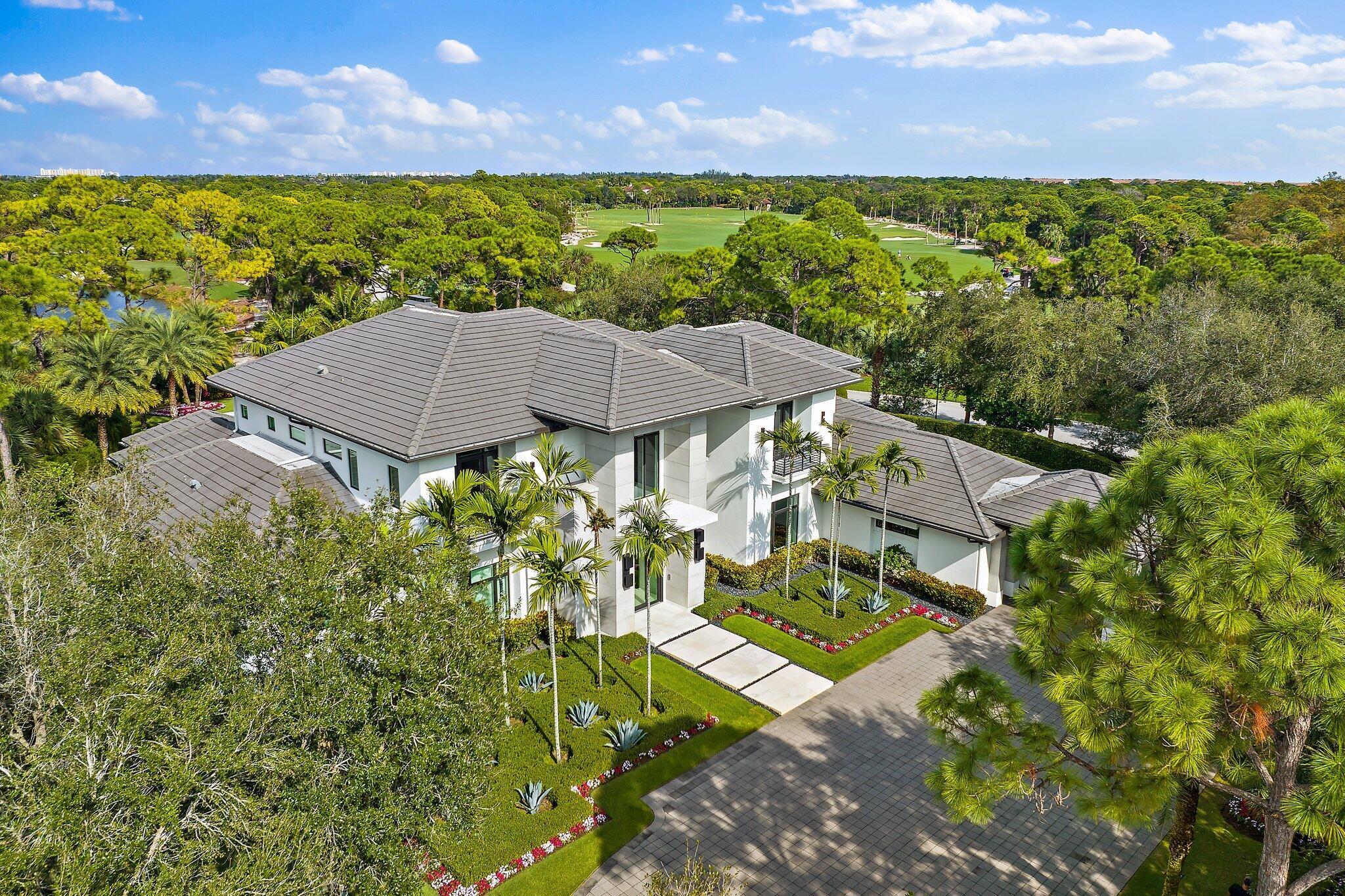 Experience the pinnacle of luxury living with this contemporary estate at 103 W Bears Club Drive. Situated in The Bears Club, a prestigious gated community just 1 mile from Atlantic beaches, this 9,100 sq ft home seamlessly blends indoor and outdoor living. Enjoy resort-style living with a luxurious pool and a summer kitchen.Nestled on nearly 400 acres and home to a Jack Nicklaus signature golf course, The Bears Club offers exclusivity with only 61 estate homes. This property boasts 5 bd, 6 bath, 4 car garage, guest house, club room, and an exquisite great room kitchen.Discover the epitome of elegance and convenience, with top-notch amenities, including restaurants, shopping, medical facilities, and easy land and sea travel, all within reach.