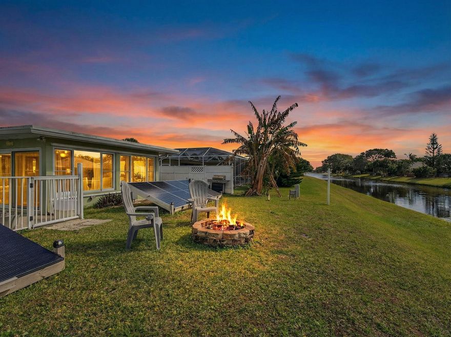 Hurricane-Ready Waterfront Pool Home | Fully Owned Solar + 18kw Battery Backup | No HOA   Experience the best of South Florida living -- where others vacation -- in this beautifully maintained CBS canal-front pool home designed for comfort, efficiency, and hurricane resilience located in beautiful Palm Beach Gardens.  This unique property offers a rare combination of energy independence, storm protection, and waterfront lifestyle, making it ideal for year-round living or peace of mind during storm season.  The home features a fully owned 2024 removable solar system with battery backups, allowing the property to operate independently if needed. The solar panels are 100% paid off and owned by the seller, and FPL does not pull power from the system. A solar-powered split 1 ton   NEW 2024 AC unit provides additional cooling directly from the solar system, helping keep electric costs low while offering reliable comfort during storm season and summer time!  Designed with hurricane resilience in mind, the home is rated to withstand a Category 4 hurricane and features new impact-rated hurricane windows and doors, along with a roof approximately 5 years old and additional structural improvements such as hurricane straps and reinforcements. The property is also equipped with an 18kW off-grid solar generator system and a dedicated subpanel for the kitchen and living room, ensuring essential areas remain powered when needed.  Inside, you'll find thoughtful upgrades throughout including all new air conditioning ductwork, a main AC system approximately 6 years old, and an upgraded 200-amp electrical panel. The home has also been fully rewired, providing modern electrical reliability.  Step outside to enjoy your private backyard retreat overlooking the canal, which flows into Lake Catherine. The outdoor space is perfect for relaxing or entertaining, solar pool heater, upgraded oversized pool filtration system, and fire pit area. A kayak and paddleboard rack makes it easy to enjoy the waterfront lifestyle.  Additional outdoor features include a new sprinkler pump drawing water directly from the canal, permanent color-changing holiday lighting, three solar roof vent fans, new gutters installed during roof replacement, and spray foam insulation in the garage roof for improved energy efficiency.  The property also offers beautiful tropical landscaping with banana trees, lemon tree, pineapple plants, and a newly planted dragon fruit plant, creating your own South Florida oasis.  Inside the home you'll find stainless steel kitchen appliances, an inviting living space, and a new living room floor.  The backyard is enclosed with fencing connected to neighboring properties, adding privacy and convenience.  Located with easy access to I-95 and the Florida Turnpike, the home is just minutes from fine dining, shopping, and some of South Florida's finest golf courses and pristine beaches.   With NO HOA, waterfront access, hurricane-resilient upgrades, and fully owned solar power, this property offers a rare opportunity to enjoy energy independence, security, and the South Florida lifestyle all in one home.