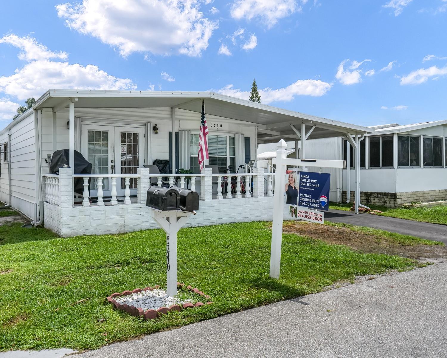 Welcome to this spacious and updated 3 bed, 2 bath home in the all-age Ravenswood Estates of Fort Lauderdale, where you own the land. The main residence features multiple living spaces, a large open-concept kitchen with custom cabinetry, in-home washer/dryer, newer flooring, and a large carport. An expanded attached shed adds two rooms and a large bathroom, greatly expanding living and bedroom potential. This special home is ready for you to make it your own. Come see it today and imagine the possibilities.