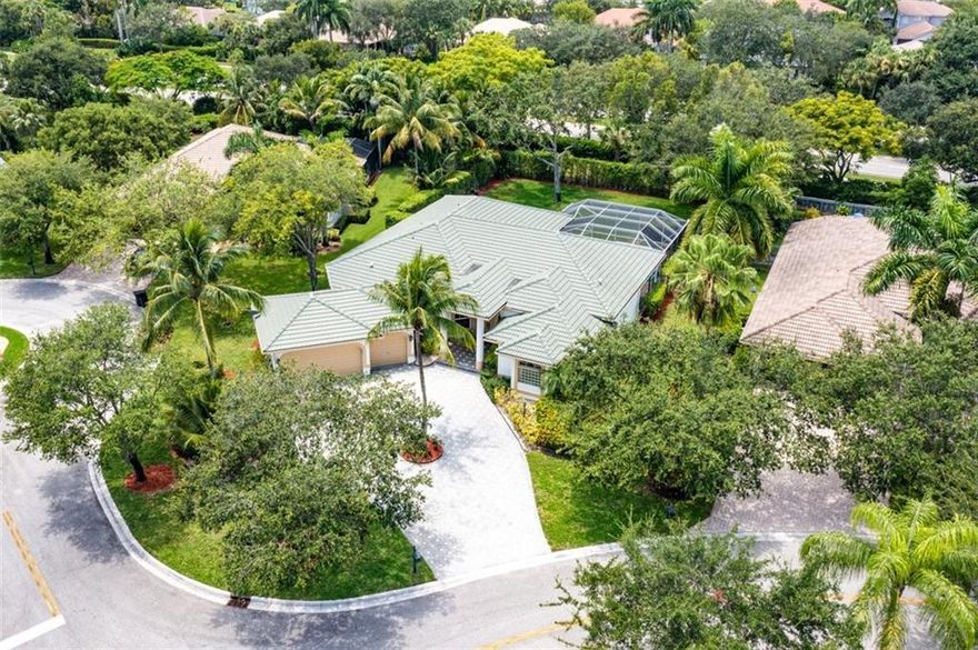 An impressive curb appeal, sprawling front lawn, & a large driveway add to this home's splendor.  A living room with a wall of windows, soaring ceilings, a bar & beautiful views of the pool & grounds greet you upon entering. The open family room/kitchen area is impressive in size, perfect for large-scale gatherings. The kitchen offers an abundance of fine cabinetry, granite, SS appliances & breathtaking "seamless butted" glass windows. A luxurious & spacious primary suite features a sitting area, spa-like bath & serene views!  The huge backyard & the resort-style pool are perfect for spending time with family & friends. A triple split design with large secondary bedrooms & private spaces makes it perfect for today's need for personal & work space. Walk to A Rate schools & parks.