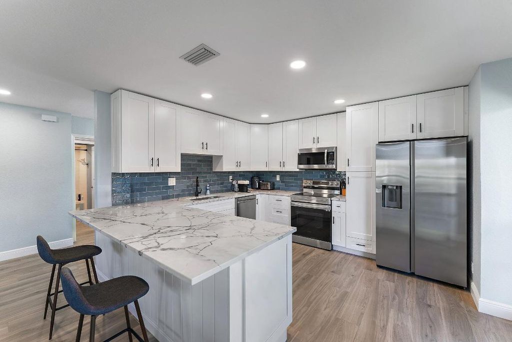 Photo of 459 Brackenwood Lane N, Palm Beach Gardens, FL 33418 (MLS # R11037420)