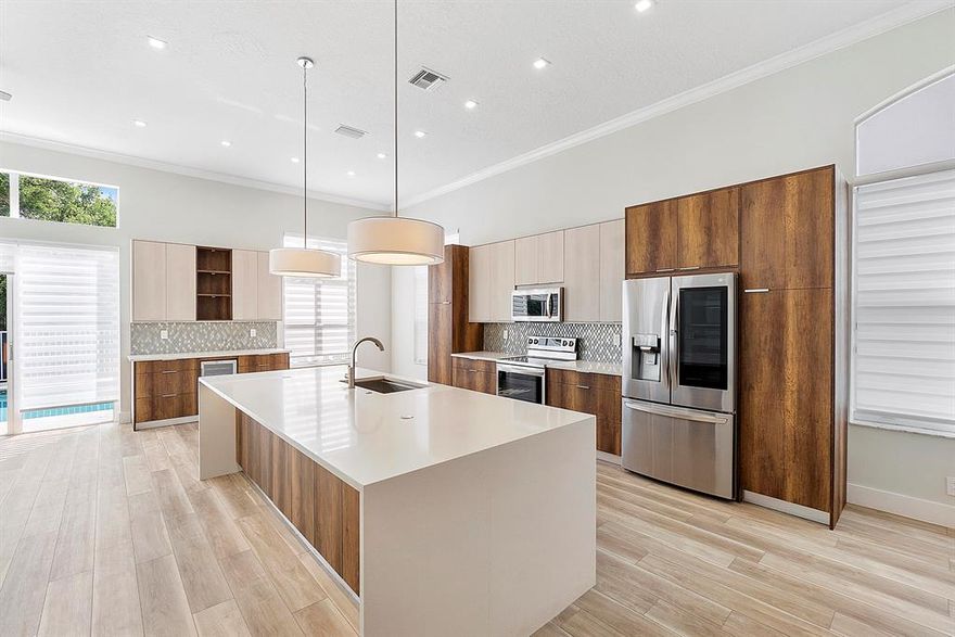 Gorgeous one story fully REMODELED pool home located in the prestigious guard gated golf community of Eagle Trace. This move in ready home has a redesigned open floor plan and spacious triple split layout featuring 4 bedrooms, 2 bathrooms and a 2 car garage.   

As you enter into the open concept main living space you will be in awe of the high ceilings and high-quality craftsmanship throughout the home.  Designed for entertaining, the large chef's kitchen comes equipped with top-of-the-line LG smart appliances, custom wood cabinetry, a beverage station and a massive quartz waterfall island featuring integrated pop-up charging stations and extra storage. Sliding glass doors with remote controlled custom window treatments lead to the oversized pool creating an inviting indoor outdoor living experience. This spacious layout also features a breakfast nook, family room, dining room and additional space that can be used for a formal area or den. 

The large primary bedroom has high ceilings, two walk in closets with custom built-ins and sliding glass doors that open to a screened in lanai with direct access to the pool. After a swim, retreat to the spa like bathroom where you will enjoy large dual quartz counter top sinks, plenty of storage and a touchless back-lit LED mirror. Not to be missed is the oversized walk-in rain shower and free-standing bathtub with waterfall feature that will make you feel like you are in a 5-star luxury hotel.  The comfort height toilet, towel warmer, chandelier and tiled accent wall add to the grandiose feel.

The secondary bedrooms of this split floor plan include laminate floors, dramatic ceilings, generous closet space and privacy from the main living areas of the home.  The fourth bedroom has beautiful glass doors and is currently being used as an office but can be converted to an additional bedroom or flex space as needed. Nice size guest bathroom with quartz counter tops, dual sinks and LED vanity lighting.  

Low maintenance landscaping runs off of well water. The front shade garden nicely blocks out the afternoon sun. Impact resistant garage door and sliding accordion shutters on all windows provide hurricane protection. 

This home has been well maintained and is full of upgrades including smart home features such as a keyless door lock, Nest thermostat, Lutron lighting and more. Luxury, waterproof vinyl plank flooring, laminate and tile throughout. Full feature and upgrade list attached to the MLS.

Eagle Trace is a luxury 24 hour guard gated golf community in Coral Springs centrally located to excellent public schools, restaurants, shopping and major highways.  The neighborhood is full of spectacular views and offers a serene Florida lifestyle.  Here residents can indulge in premier amenities such as tennis courts, playground, pickle ball, basketball and more.  There are no mandatory membership fees required. Low HOA of $250 per month.