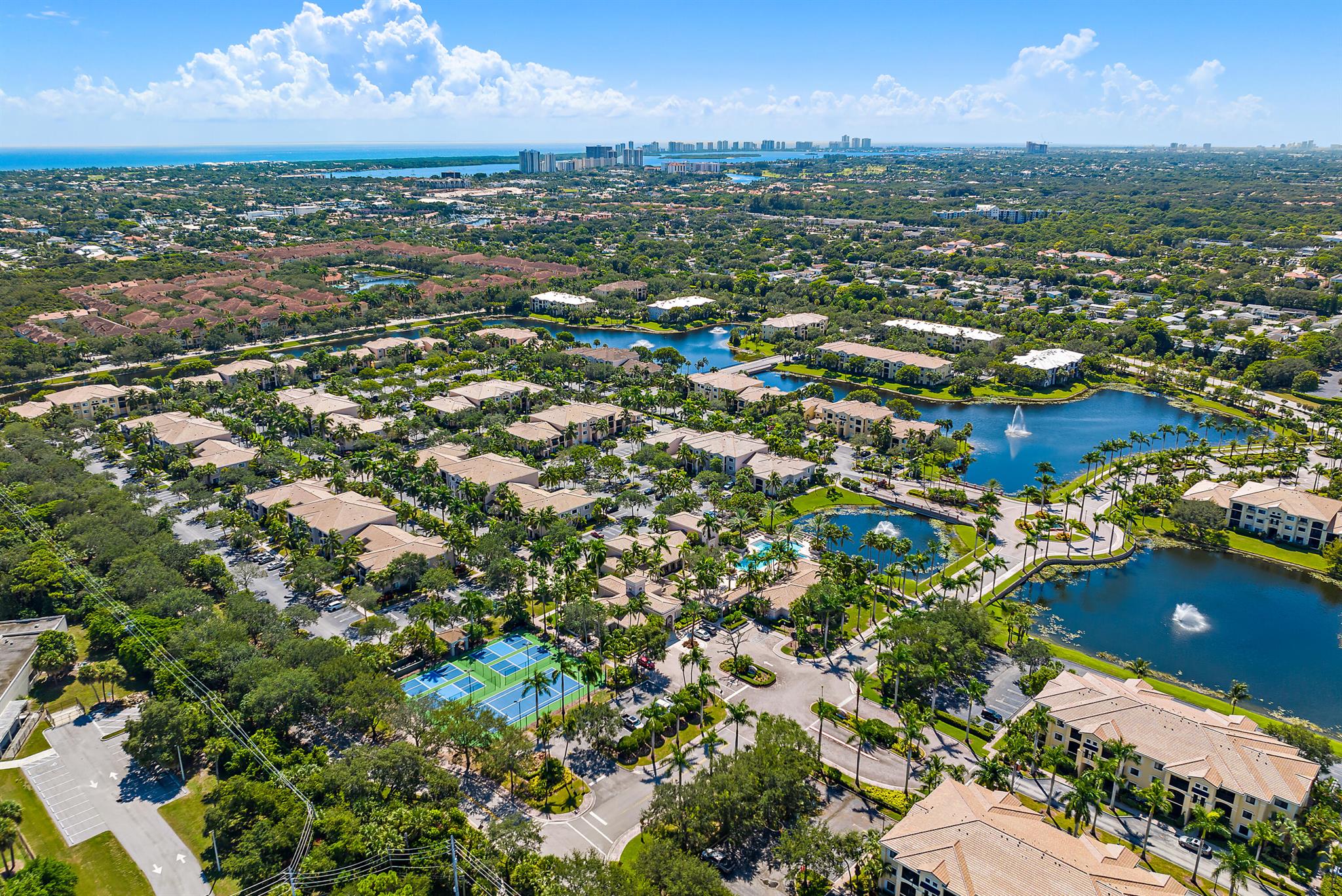 Enjoy meals in gorgeous, south-facing, quiet, lakefront, screened lanai in a spacious, clean and contemporary townhome with 3BRs (2 are master suites) all with ample closets, 3 full baths+storage room+garage offers space for a vehicle and storage for bikes, BBQ, beach apparel etc. Very few units offer this amount of space, layout, magnificent lake view, private parking spots at the front door, proximity to amenities such as renovated tennis and pickleball courts, beautiful pool and deck area including hot tub, sauna, steam room, well equipped gym with racket ball and B-ball hoop. The common area around the pool and gym also boasts an area for hosting parties, pool and ping pong tables and a meeting room for owners' use. San Matera is perfectly located close to I-95 and the Gardens Mall.
