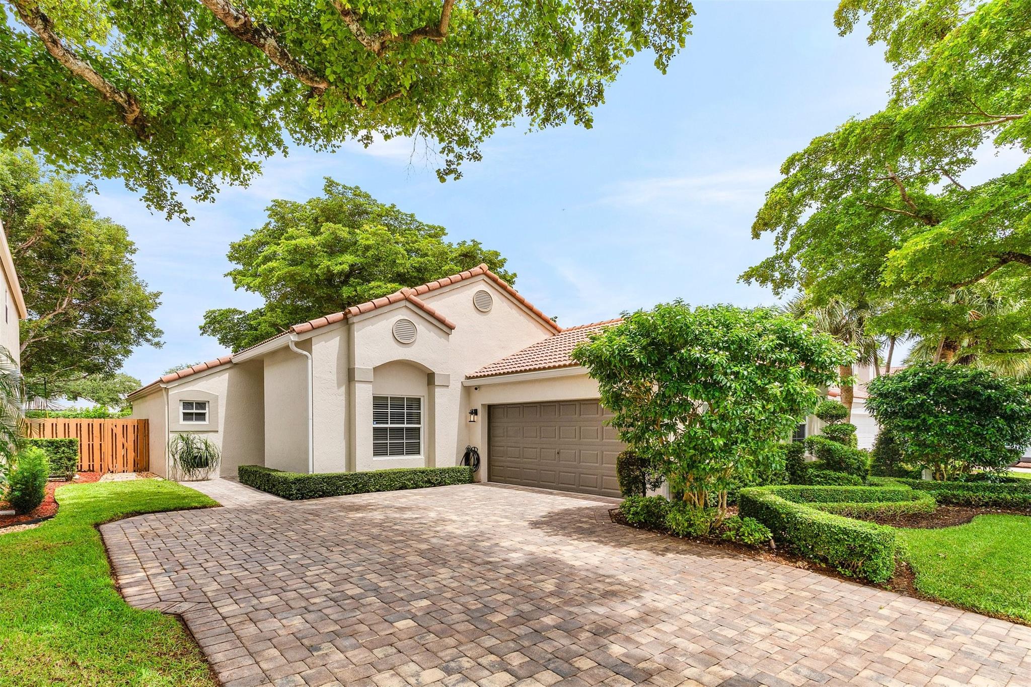 Truly a stunning home—completely reimagined & updated with exceptional finishes, premium materials & meticulous attention to detail throughout. From the moment you arrive, the pristine curb appeal, manicured landscape & expansive paver driveway set the tone for something special. Inside, the sunlit white kitchen shines with a large waterfall island, stainless steel appliances, a spacious wine refrigerator, & abundant natural light. The home features all impact windows & doors, a newer roof, slatted door/wall, serene backyard retreat with thoughtfully designed outdoor living areas & summer kitchen. Every space is magazine-worthy—this home is a must-see! Great Location! Walk to parks, shopping & dining. The beach is only 7 miles down the road. HOA provides lawn maintenance. A rated schools.