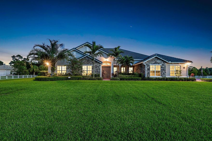 If you have been searching for a newer construction single family home with a luxurious outdoor space in an esteemed gated community, THIS IS IT! Welcome to 10096 Calabrese Trail in the highly sought after gated community of Reynolds Ranch in Jupiter Farms. Situated on a 1.5 acre lot and offering over 5,200 sq ft, your exquisite new main home has four oversized bedrooms plus an office, 3.5 baths AND your detached guest house has its own 1 bedroom and 1 bathroom! Boasting impact windows and doors throughout, CBS construction, and an outdoor oasis equipped with a heated saltwater pool and spa, full summer kitchen, and tranquil views of the blue lake. Enter the front doors of your new home and be swept off your feet by the abundance of natural light, soaring high ceilings and
