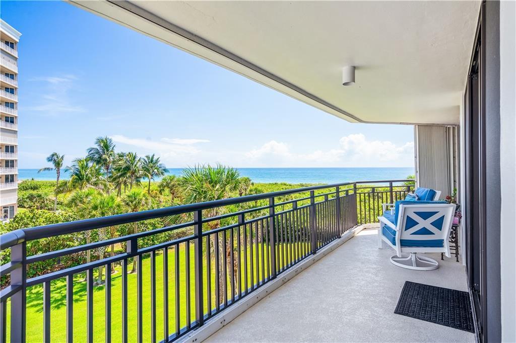 Life's better in turquoise. This 4th-floor corner condo captures breathtaking ocean views from its expansive wrap-around balcony; your private front-row seat to paradise. Inside, natural light floods the open layout showcasing a modern kitchen w/granite counters, breakfast bar, & sun-drenched dining nook. Daily ease is assured w/in-unit laundry, covered parking, & essential impact glass. Indulge in a pool, spa, fitness center, & private beach pavilion offering direct sand access. Nestled in an idyllic oceanfront location, you're also mere moments from the Intracoastal & miles of nature trails.