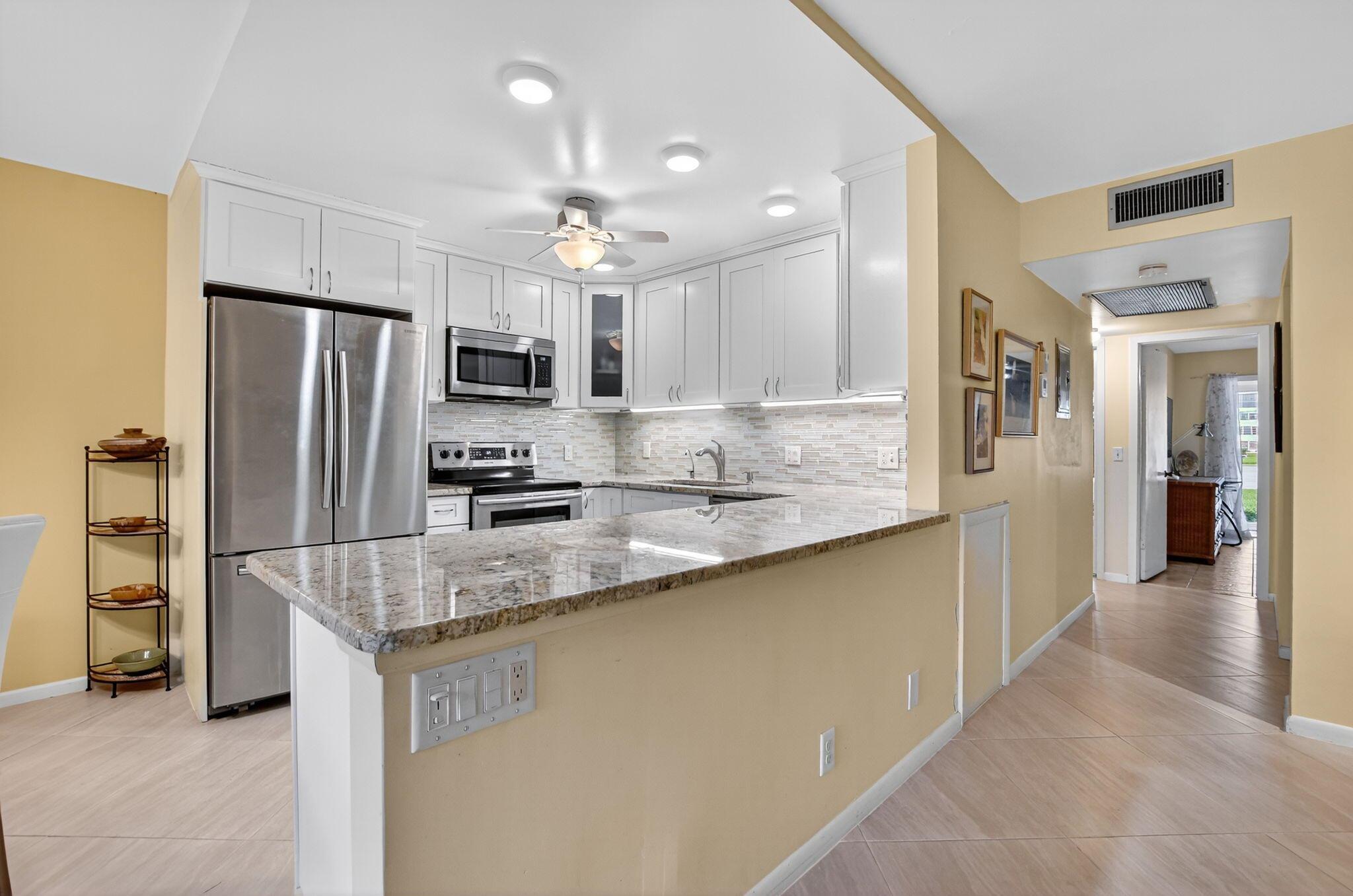 Beautifully Updated 2/2 condo in the Wolverton section of Century Village Boca Raton. A Short walk to Beth Shalom & Main clubhouse. This bright and spacious home features an open layout with a large living area and an open kitchen with great cabinet space and natural light. Both bedrooms have sunset lake views. A screened balcony with IMPACT SLIDERS lake views. The primary suite includes a walk-in closet and ensuite bath. Updated Electric Panel(2023) Impact Sliders. Enjoy a prime location close to the heated pool & clubhouse. Century Village has resort-style amenities including a fitness center, theater, tennis, pickleball, a courtesy bus, and 24-hour gated security. Conveniently located near shopping, dining, and major highways--perfect for enjoying the South Florida lifestyle! AC 2