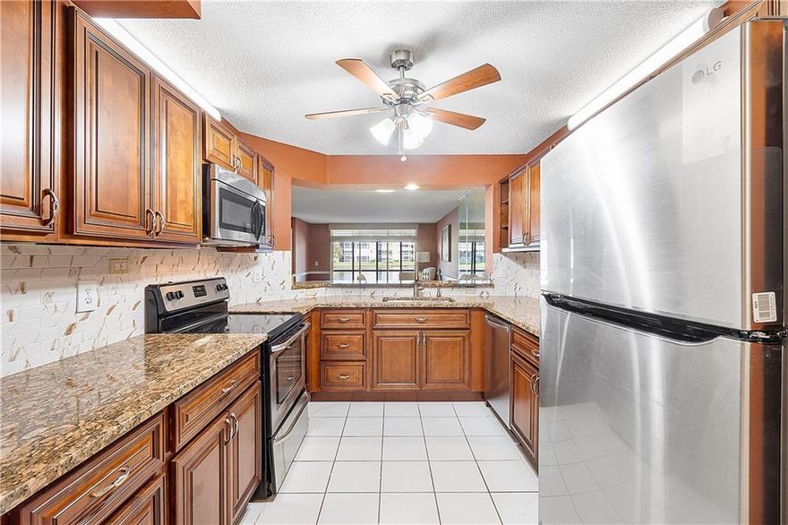 DONT MISS THIS PROPERTY, Park at your front door for easy access! So many upgrades! Spacious entry into a NEW updated kitchen. Fantastic NEW wood cabinets are outstanding with stunning granite counters and a fabulous NEW backsplash. The dishwasher and fridge are also NEW. Plenty of light in the roomy kitchen eat in area, which is perfect for a dinette OR can be made a den! NEW bath vanities, sinks AND toilets. A large primary walk-in closet provides organizer shelves. The NEW flooring is hardwood oak (with xtra supply). Relax & watch the gorgeous, vast water view on your private porch! Sliders offer extra protection of the screen enclosure which is perfect to keep porch extra secure and dry. Fresh paint throughout. Building security cameras with the entrance gate make this a lucky find!