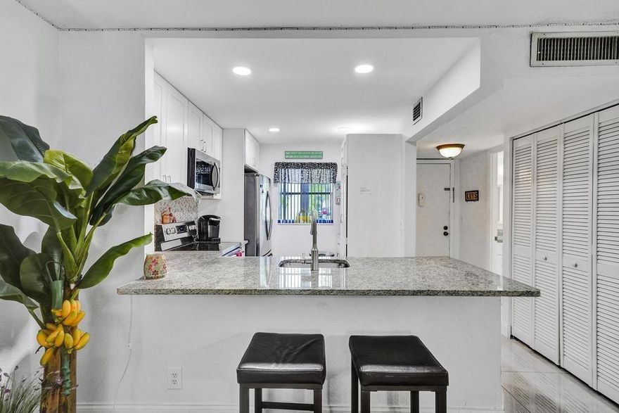 Remodeled in 2021, move-in ready. Ground floor unit offers easy access from parking lot to front door. Enclosed porch/Florida room adds space. Elegant 24" porcelain tile throughout. White Shaker 42" kitchen cabinets and granite counter tops in the kitchen. Pantry and additional cabinets were added to make this kitchen second to none. 55+ community with amazing clubhouse and amenities.