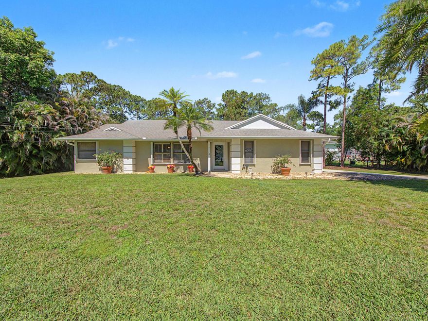 Rare Jupiter Farms opportunity on 1.09 acres! This 3BR/2BA home offers 1,835 sq ft under air w/ a split floor plan & walk-in closets in all bedrooms, plus multiple living areas including a spacious 25' x 17' den w/ fireplace, formal living & dining rooms. Enjoy Florida living in your screened-in pool & covered lanai, perfect for relaxing or entertaining year-round. Private, lush setting w/ room for boats, RVs, animals, hobby farm or workshop. Hurricane protection (storm shutters) & NO HOA—bring your toys! Major updates include A/C (2016), septic (2024), well shaft (2020) & water filtration (2020/2025). Experience true Florida country living w/ space, freedom & privacy, all just 15-20 min to Jupiter Beach, inlet, dining, shopping & I-95/Turnpike.