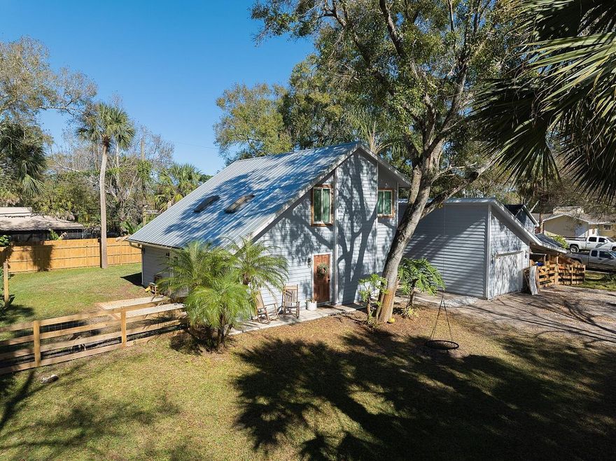 Welcome Home to Space, Privacy & Possibility in Pine Tree Park. Hidden behind mature trees and natural vegetation, this thoughtfully renovated home sits on a rare double lot totaling .34 acres, offering a level of privacy, flexibility, and freedom that's increasingly hard to find in Vero Beach with no HOA restrictions. As you arrive, the tree-canopied setting, paver patio entry, and fully fenced yard immediately set a calm, welcoming tone. Inside, the home opens up with vaulted ceilings, skylights, and abundant natural light, creating an airy, inviting atmosphere. Wood-look luxury vinyl plank flooring flows throughout the living spaces, complemented by tile in the bathrooms for a clean, cohesive feel. The home features a desirable split-level layout, with the primary suite