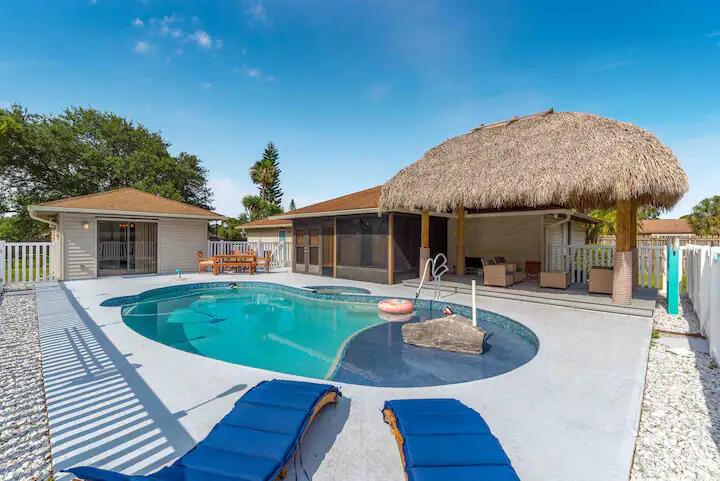 Tropical paradise for rent! Main house has 2 oversized bedrooms and 2 baths, with a 1-bedroom, 1-bath cabana guest cottage overlooking the stunning pool with sundeck. Tiki porch, fenced pool area, mature trees, and fenced yard on almost half an acre!. Located in a quiet family neighborhood east of US 1. Partially furnished. Minutes from the beach, shopping restaurants, & nightlife, the location is incredible for living your best Florida life!