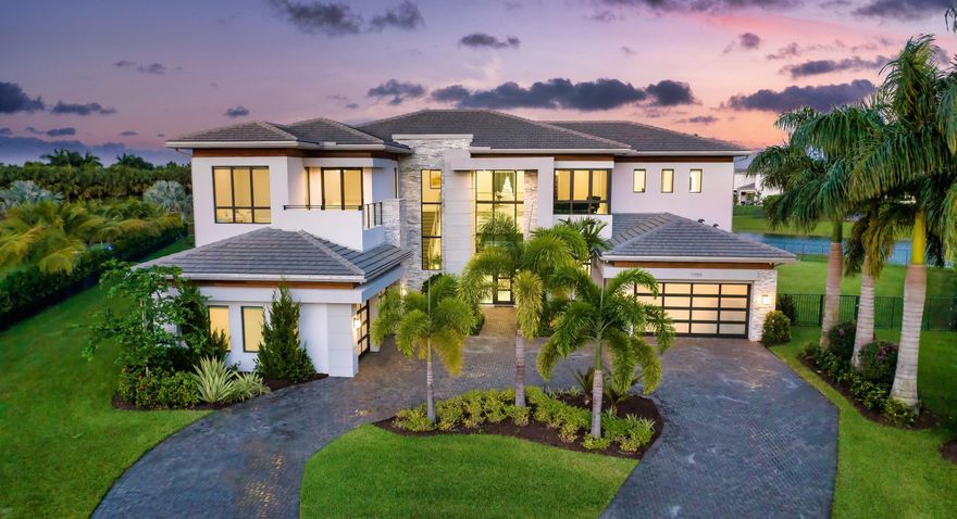 Boca Bridges Expansive Lakefront Estate  Quietly tucked away in a private cul-de-sac and nestled on an oversized 0.72 +- acre lot, this coveted Vanderbilt Grand Contemporary model spans 11,873 +- square feet of exquisite living. Featuring six commodious bedrooms, eight full and two partial bathrooms, four car garage, custom and upgraded accents, and luxuriant outdoor living space, this sprawling pristine lakefront estate was constructed by the prestigious GL Homes in 2020 and is the largest model offered at Boca Bridges.