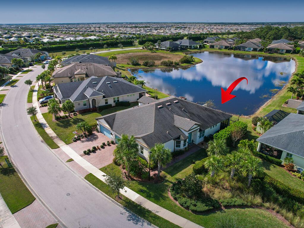 Lakefront living in this spacious 2/2/2 Villa plus large flex room! Lake Park is an active 55 plus gated community loaded with amenities. A perfect blend of coastal charm and modern touches await. The kitchen boasts stainless appliances, pantry & center island flowing into the living & dining rooms & covered, screened patio AND special pet friendly fencing AND lake location. Ideal for entertaining or daily relaxation. Airy, open layout, large master suite, fabulous built in closet organizers. Tile on the diagonal throughout, freshly painted interior, plantation shutters the master and living areas. Impact glass windows & doors throughout, generator hookup new A/C in 2024. 2 car garage complete with floored attic space, 30 amp electric car outlet plus extra electrical outlets for wor