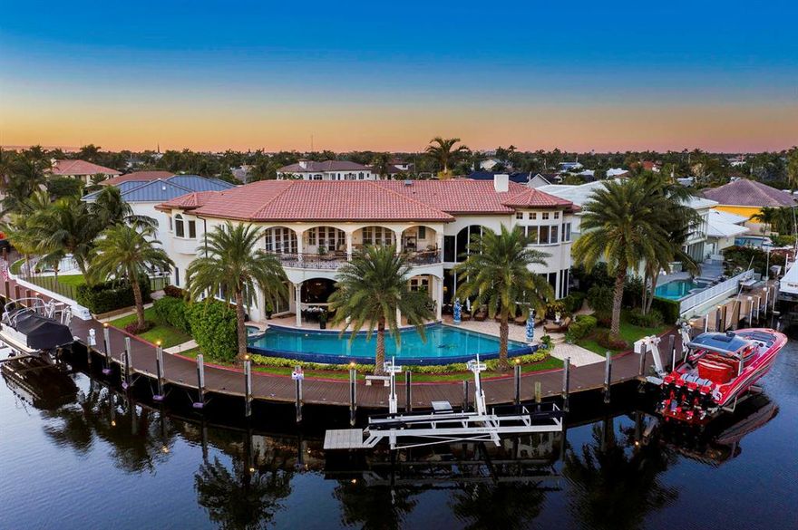 Welcome Home to the Boating Lifestyle with Breathtaking Big Water Views from this exquisitely designed waterfront point lot home. Deep Water, Ocean Access & No Fixed Bridges, New Decking for 260' of Dock & 3 boat lifts. This stunning home boasts a ground floor bedroom & a private master suite with his & her separate bathrooms & huge walk-in closets, sitting area & expansive covered balcony. A true gourmet kitchen with Viking & subzero stainless appliances, granite counters & wood cabinets. Many custom touches throughout include Elevator, Generator, marble, travertine & wood floors, a grand Wood & wrought iron staircase, impact windows, designer paint, plantation shutters, a pool & spa, summer kitchen & much more. Quiet cul de sac with friendly neighbors-You'll LOVE this home