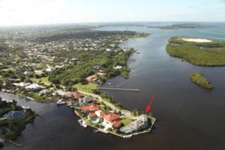 A TRUE point location with almost 300 degree water frontage.  The most breathtaking views around.  The wrap around deck, screened in pool area and screened in porches utilize the spectacular views for a true island feel.  The second story master suite boasts a large private sundeck maximizing the serene water views.  A dock and two boat lifts make it the boaters dream.  A must see.