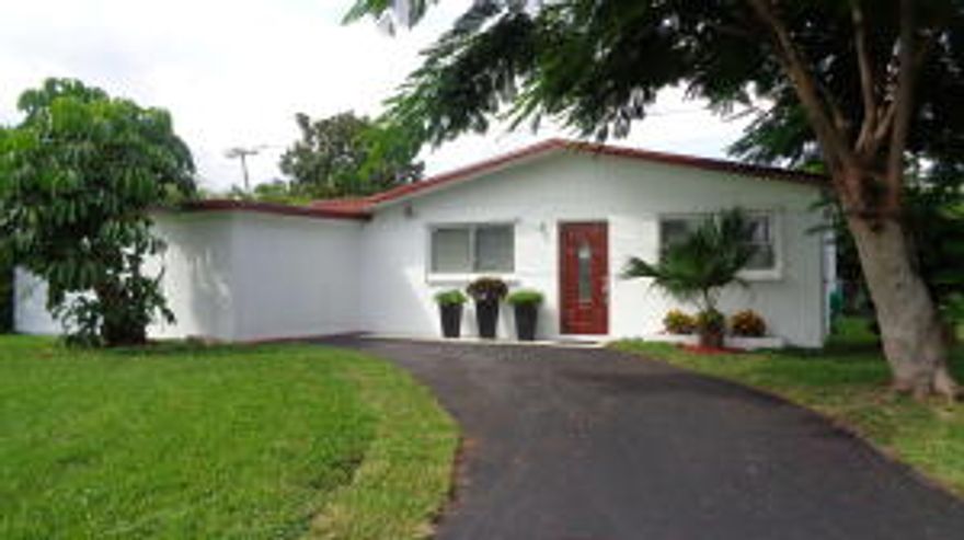 This home is in move-in condition with a brand new kitchen, tiled bathroom, upgraded exterior doors, exterior and interior paint and laminate wood floors throughout. Other features include: a spacious fenced-in back yard with room for a pool that backs up to a canal for privacy; a large concrete patio for entertaining; separate walk-in laundry area; lighted ceiling fans; 8 year old roof; enclosed carport for storage or workshop and hurricane shutters for all windows. A great location with nearby access to I-95, this is the perfect starter home nestled in a quiet neighborhood within walking distance to all grade level schools, grocery, dining and shopping centers.