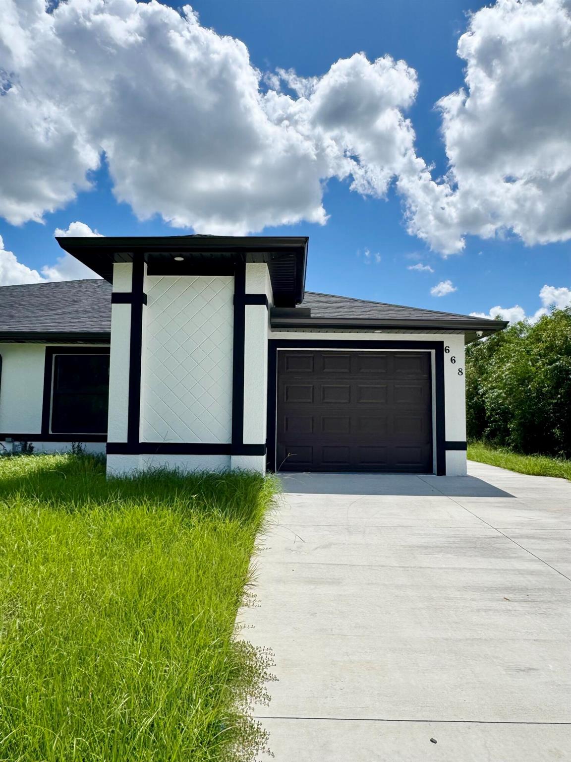 Brand new construction 3 bed/2 bath townhome/villa in Lehigh Acres (33974) -- AVAILABLE NOW! Modern open layout with high ceilings, luxury tile throughout, and stainless-steel appliances to be installed. Private garage plus driveway parking, irrigation system, and a spacious yard. Be the first to live here! $2,200/month; move-in specials available--first, last  & security negotiable. Vouchers welcome. Convenient to schools, shopping, and major roads. Schedule a tour today!