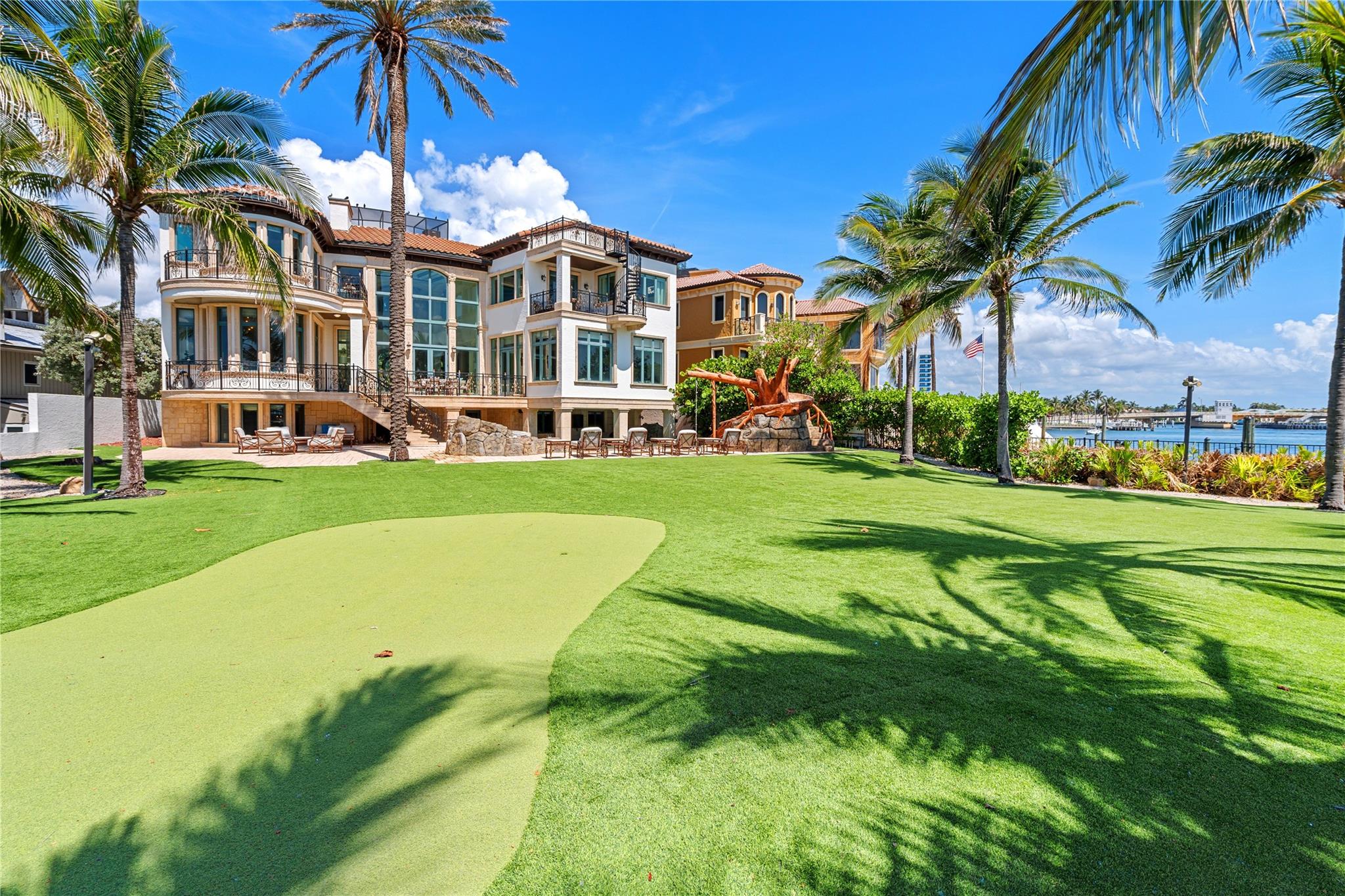 Rare Oceanfront Estate On Hillsboro Point! Located in the sought-after enclave of Hillsboro Shores, this exquisite estate is a masterwork of design, where nearly every principal room opens to a terrace or balcony framing sweeping sunrise views of the Atlantic Ocean, the Hillsboro Inlet and the iconic Hillsboro Lighthouse. Sited on over half an acre, enjoy three levels of luxury living including oversized primary suite, custom chef’s kitchen, & decorative detailing throughout. Features include elevator, 4-bay garage, theatre, custom wood paneled office, gym, impact windows/doors, Lutron lighting, putting green, observation deck and more. Outdoor entertainment is enjoyed at the verdant lawn and the resort style pool with swim up bar, tree house slide and spill over spa. Private Beach Access.