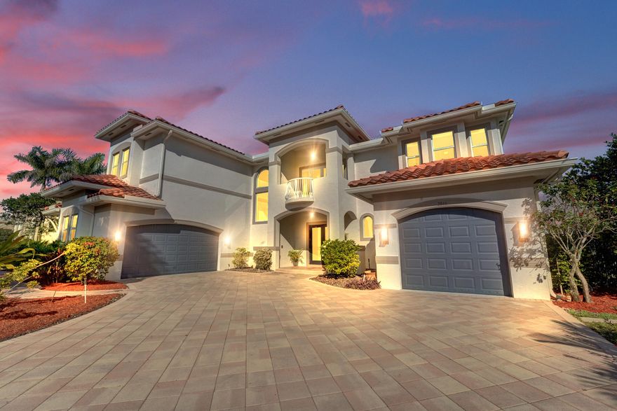 Experience true luxury living in this stunning 5 BR 6 BA estate on a massive (near 1 acre) lot complete with a brand new sparkling Van Kirk designed saltwater pool and spa, overlooking the lake. New roof, AC and impact windows! Towering floor to ceiling windows draw in an abundance of light to every room. Enjoy the spectacular water views from the moment you enter your home and its grand foyer. The large impressive living room w/ wet bar and the bright kitchen open up to your oasis backyard making this a true indoor-outdoor home, perfect for entertaining! Your immense backyard is surrounded by lush mature fruit trees adding to its tropical feel and lending much privacy. No detail has been spared. New gourmet kitchen with an oversized island & gorgeous marbled Brazilian stone countertops,  new Monogram double oven, smart wi-fi appliances, a walk-in pantry, including the custom led lighting makes for a very light, appealing open kitchen. This expanded Van Gogh model gives you the convenience of a bedroom on the main floor for guests or a live-in nanny. Main level also features a true dedicated substantial home office with large bookcases, plenty of shelving and room for two. Your private dining-room is stunning, with coffered ceilings, a picture window letting in lush, green garden views and light while comfortably seating 12 for dinner parties. NEW ROOF and AC. NEW IMPACT WINDOWS! On the second story, enjoy a grand primary BR overlooking the water, his & her separate walk-in closets and a very large spa like bath with whirlpool jacuzzi tub. You have 3 additional bedrooms all with their own en-suite bath, a loft/media room which opens to an expansive covered balcony, overlooking your private backyard water oasis. Living here, you feel like you are on vacation every day! The epitome of Florida lifestyle! Ample consideration for cars here with 2 garages and an extended driveway to fit many more automobiles. Adding to convenience for electric vehicles you have not one but two EV stations. Utilizing modern technology this smart home offers Savant home automation system for integrating lighting, climate, entertainment, security and energy from one customizable interface. Long Lake Ranches is a coveted guard gated community known for its proximity to THE TOP-RATED SCHOOLS in the nation! Amenities include clubhouse, fitness center, tennis courts & basketball court. You are near equestrian trails & the scenic Tree Tops Park and minutes to great dining, restaurants and entertainment. This home provides the perfect mix of luxury, privacy and location.