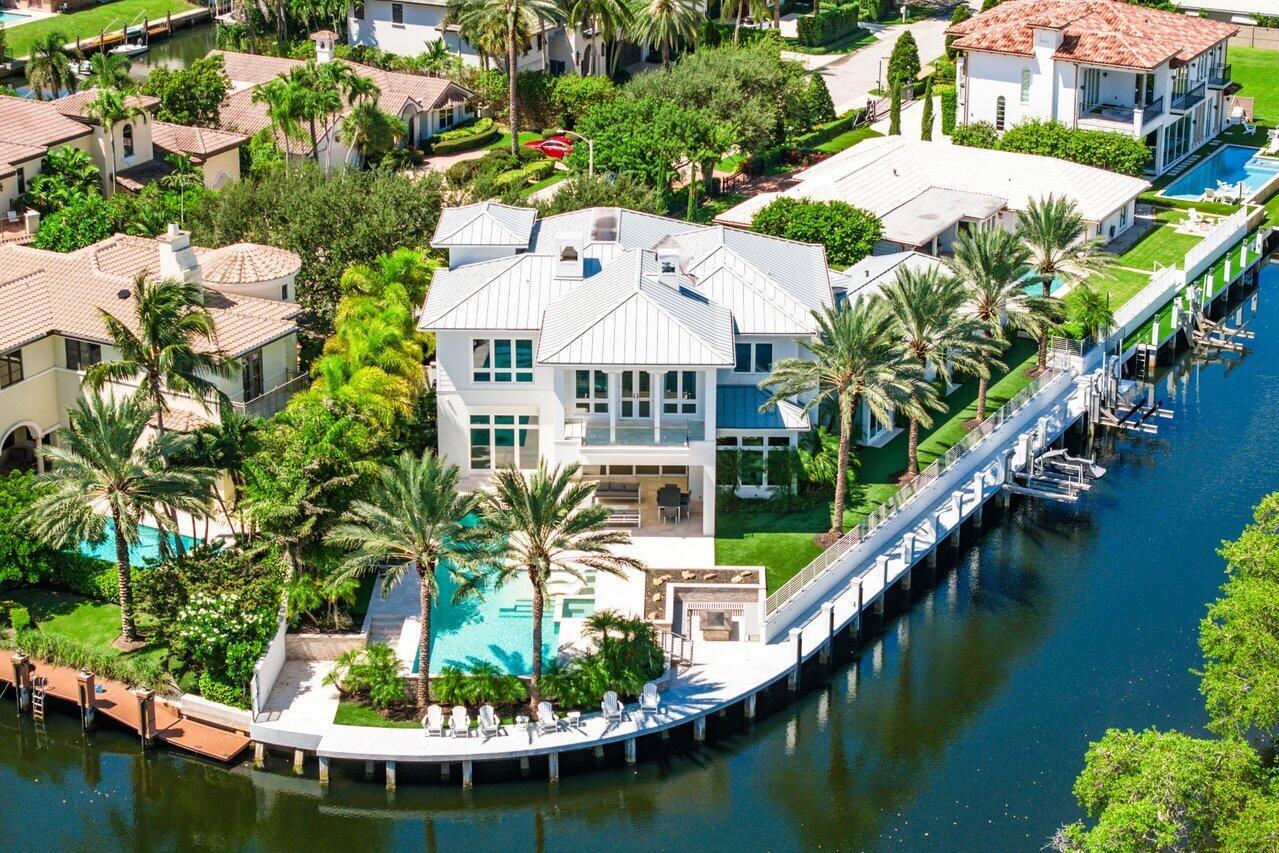 Presenting 551 NE Waterway; a east-facing waterfront point lot marvel boasting an impressive 200+ ft of waterfront dockage with a total of 7,983sf. This expansive 5/4.1 with bonus truly one-of-a-kind property located in Boca Raton's prestigious Golden Harbour. Inside, the open-concept layout welcomes natural light, highlighting custom finishes & creating a seamless flow throughout the home. This residence isn't just a home--it's a curated art gallery with soaring ceilings throughout. The expansive primary suite includes generous closets, a private balcony overlooking the water, a massage room and a lavish windowed master bath designed for indulgence. Outside, the infinity-edge pool flows effortlessly into panoramic water views. Complete with a gas fire pit, boat lift and jet ski lif