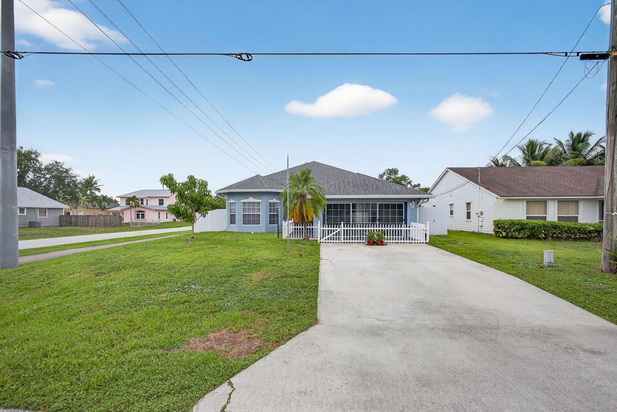Beautifully maintained 4 bedroom, 2 bath home in the desireable Jupiter Heigths neighborhood. Builder's model home, only one in the neighborhood. Open floor plan from front to back with soaring cathedral ceilings. Desirable fenced corner lot with both tiled front patio, and screened back patio, home office, eat-in kitchen with solid ceramic tile and wood laminate floors in all living areas. French doors lead to patio. Master features tray ceiling, walk-in closet, spa tub, separate shower and dual sinks. New roof installed 2020.
