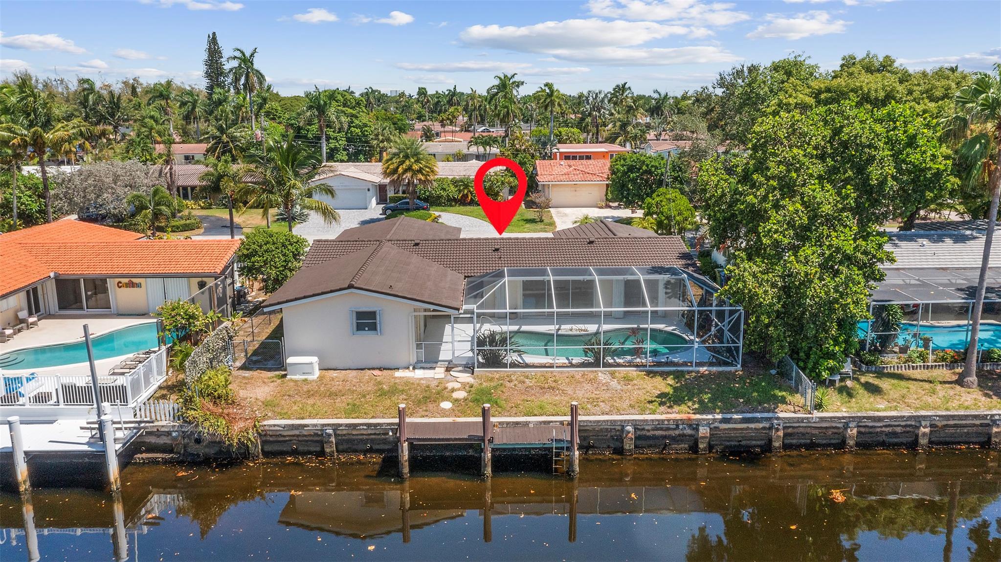 Bring your boat and vision! This waterfront gem in a quiet Fort Lauderdale neighborhood is priced below market value and loaded with rare features. Enjoy 75 feet of seawall, a 22 ft boat dock (lowest bridge clearance 7 ft, 5 bridges to the ocean), and a screened pool perfect for relaxing or entertaining. Home features include original polished terrazzo floors, new central A/C (2023), an upgraded kitchen, accordion hurricane shutters on all windows, and a newer roof for peace of mind. You’ll also find a natural gas Generac generator that starts automatically during power outages, an upgraded electrical system, a two-car garage, and a working sprinkler system. Quiet street yet close to beaches, dining, shopping, and major highways.