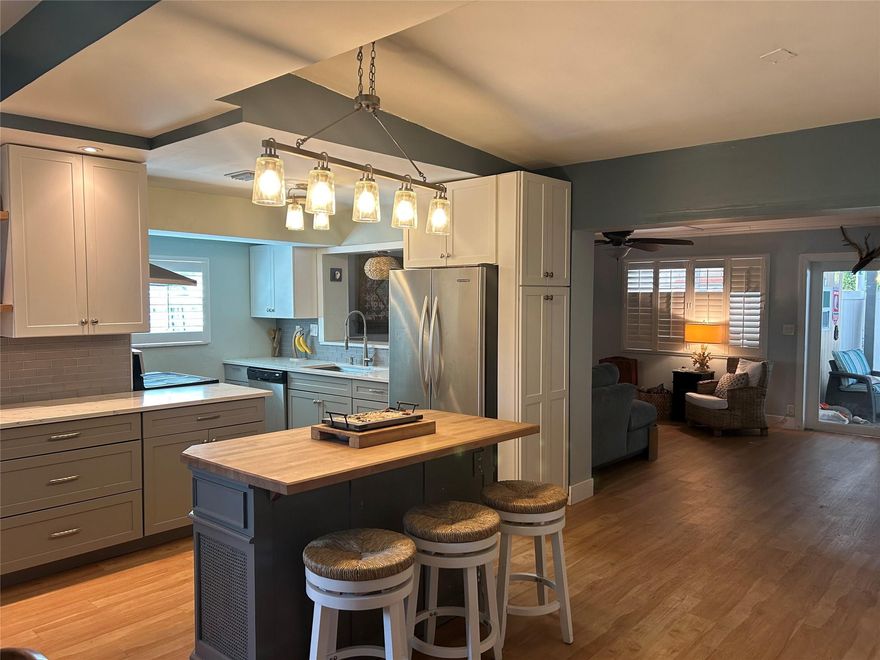 Beautiful 2 bedroom 2 bath ranch featuring a renovated kitchen, open floor plan and hardwood floors throughout. Enjoy a spacious living area that flows seamlessly into the kitchen and dining area - perfect for entertaining. Step outside to a fantastic outdoor living space with private fenced in yard that is ideal for relaxing, grilling, or hosting friends and family. The property also offers plenty of parking and a putting green. Located just minutes from beaches, restaurants, and shopping. This home combines comfort, convenience and the South Florida lifestyle. His and hers outdoor sheds with electric. New PVC plumbing under house. Appliances and Green Egg smoker included AS IS. No HOA.