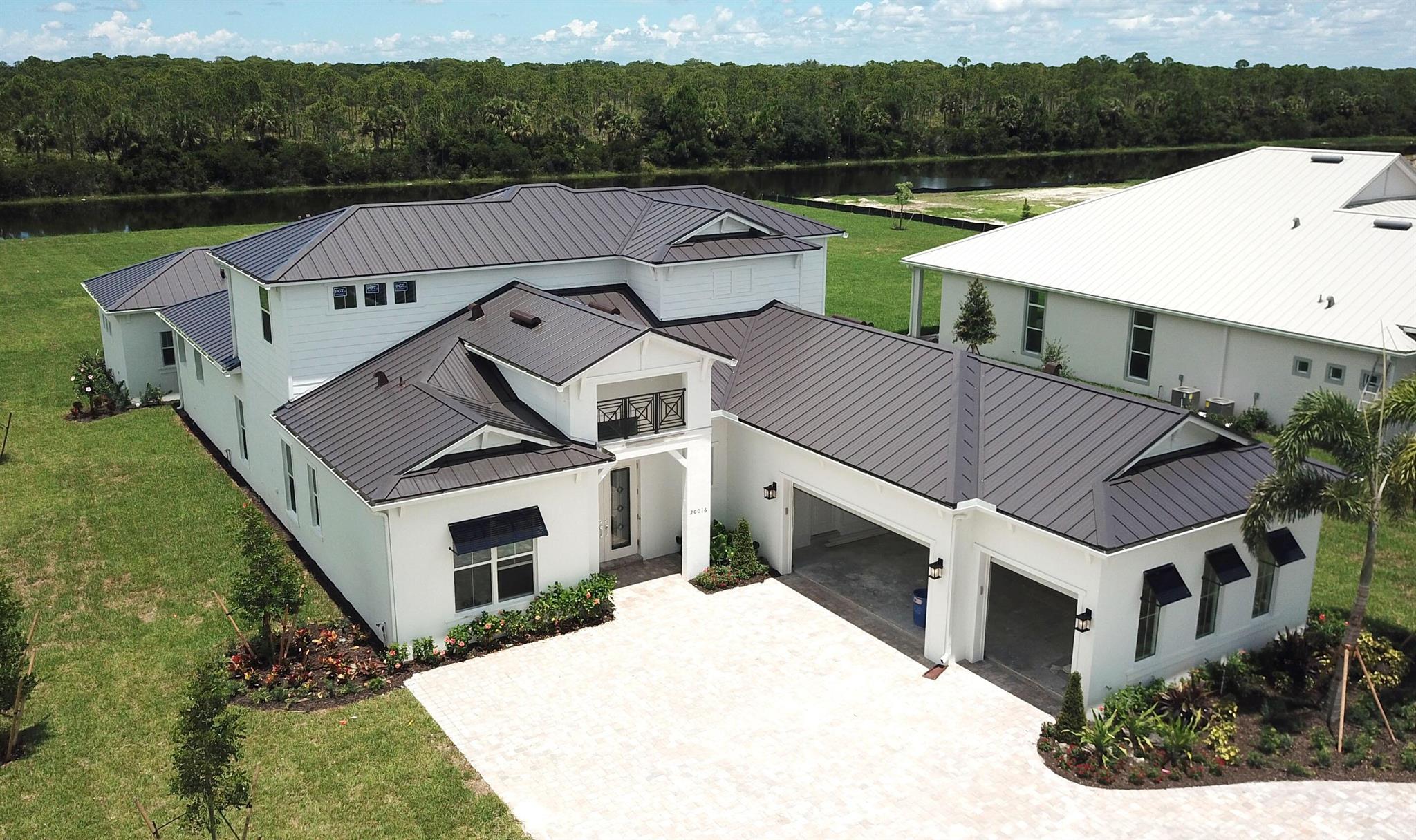 NEW CONSTRUCTION: Welcome to this stunning 6-bedroom, 6.5 bath Aventura floorplan home. Nestled on one acre of land with gorgeous sunset views. This home is impeccably adorned with on-trend finishes throughout. The kitchen is a culinary delight, boasting quartz countertops and modern double stacked cabinets. Relax in the spacious ground floor owner's retreat with door leading outside. The additional bedrooms and living spaces offer comfort and versatility for your family's needs. Outside, enjoy entertaining on the oversized covered lanai and bonus guest casita with a stunning lake view. This highly sought after Jupiter community is selling fast. Don't miss out on experiencing luxury living at its finest - schedule a viewing today! Estimated completion August.