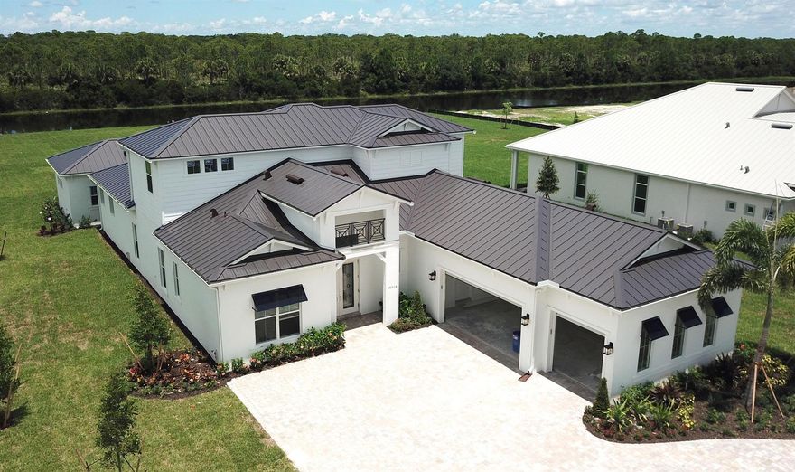 NEW CONSTRUCTION: Welcome to this stunning 6-bedroom, 6.5 bath Aventura floorplan home. Nestled on one acre of land with gorgeous sunset views.  This home is impeccably adorned with on-trend finishes throughout.  The kitchen is a culinary delight, boasting quartz countertops and modern double stacked cabinets. Relax in the spacious ground floor owner's retreat with door leading outside. The additional bedrooms and living spaces offer comfort and versatility for your family's needs. Outside, enjoy entertaining on the oversized covered lanai and bonus guest casita with a stunning lake view.   This highly sought after Jupiter community is selling fast. Don't miss out on experiencing luxury living at its finest - schedule a viewing today!  Estimated completion August.