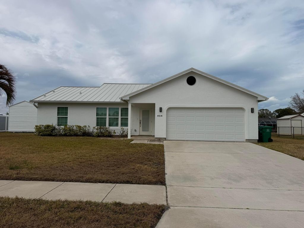 Photo of 404 NE Camelot Drive, Port Saint Lucie, FL 34983 (MLS # R11162914)