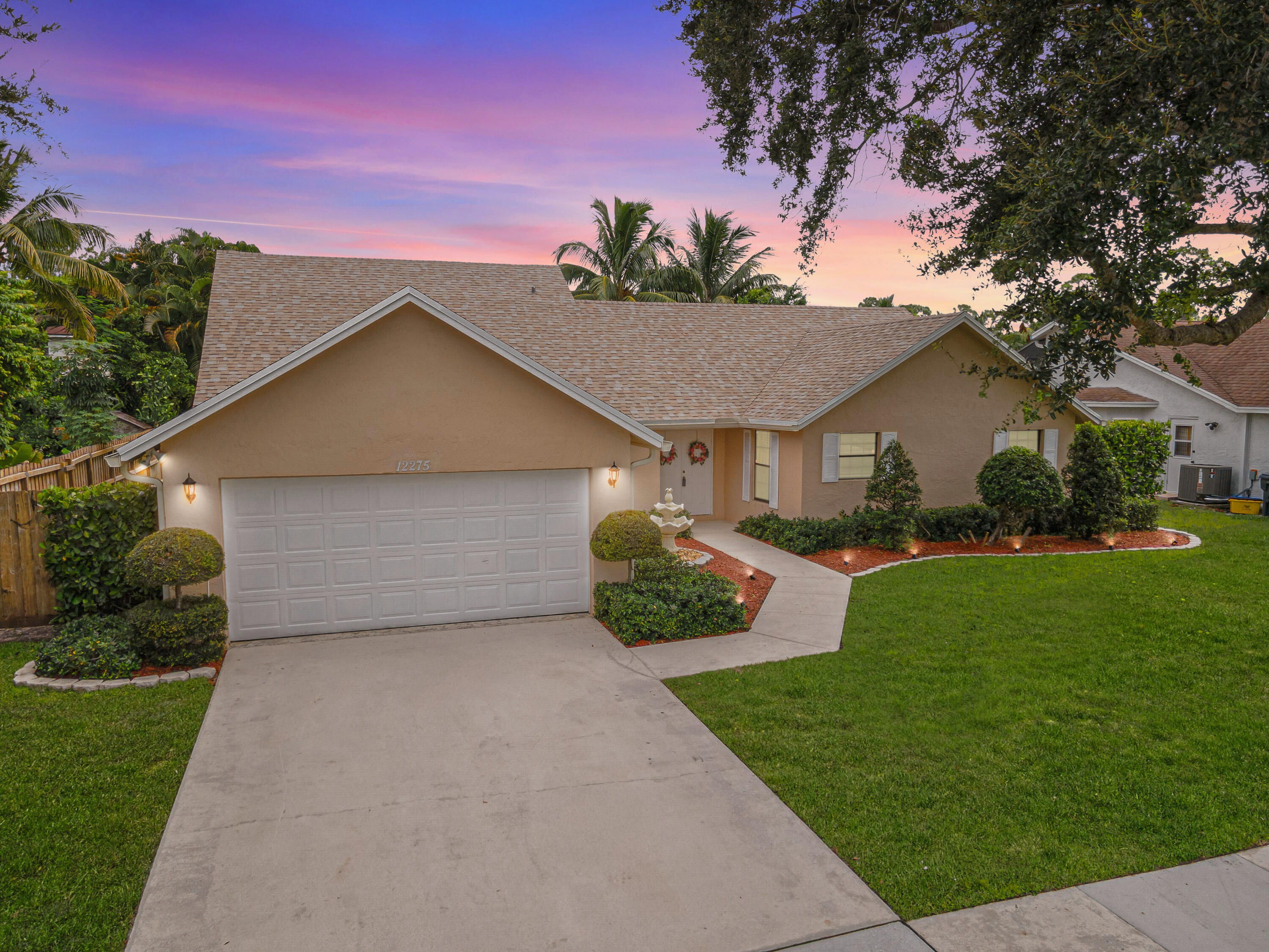 Welcome to your Wellington oasis! Beautifully maintained 4 BR, 2 BA + den home on a private 1/2 acre lot in Pinewood East, one of Wellington's most desirable NO HOA communities. Move-in ready with a NEW ROOF (2025), freshly painted interior, tile flooring throughout, updated baths, stainless steel appliances & newer central A/C. The fully fenced backyard features lush landscaping, an updated sprinkler system & plenty of room for a pool. Step outside to your own private retreat with a fully fenced backyard & plenty of room for a pool. Whether it's peaceful mornings on the patio, weekend gatherings with friends, this backyard is designed for both relaxation & entertaining. This home offers the perfect balance of lifestyle, comfort & convenience in one of Wellington's most desirable locations