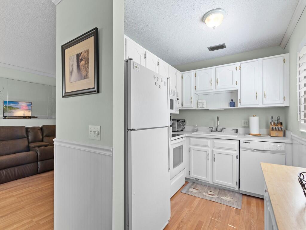 PRICE SLASHED AGAIN on the best priced turn-key first floor condo in Vista Gardens 10 minutes to the beach. Move right in this fully furnished unit w/ Laminate wood floors throughout, tile in upgraded bathrooms, Plantation shutters in main living areas, Nice bright kitchen, wainscotting, crown molding, and chair rail. Spacious patio overlooking spectacular garden area & lake. Step out your back door and enjoy nature in the meditation garden under the oak trees and feel the breeze off the lake. This condo is in a great location w/ convenient access to everything. Active 55+ comm features pool/spa, golf, billairds, shuffleboard, tennis, fitness center, clubhouse & more. Condo fee includes all amenities, all ext maintenance, roof, water, sewer, and cable. Washer & dryer can likely be added