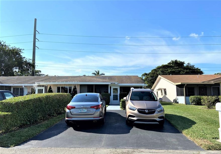 Beautifully updated CORNER VILLA in the PET FRIENDLY community of Delray Villas. This spacious Villa features solid wood cabinets through the length of the kitchen and dining room, GRANITE countertops, porcelain tile flooring through out all living areas and laminate in the bedrooms, crown molding and plenty of closets for storage. The large front porch is screened and landscaped with a ceiling fan and large storage closet.  Energy efficient HURRICANE rated IMPACT Windows and Doors through out. All appliances, a/c and hot water tank are 2016 or newer. BBQ area in the back. And even better the Heated Community pool located just a few doors down. Main clubhouse located on El Clair Ranch Road and offers to all residents a heated pool, tennis, pickleball, exercise room. Clubs & activities. One Pet allowed up to 20 lbs. Come to Florida and join the fun in the sun. Close to beaches, shopping and medical. Steps away from the famous Atlantic Ave