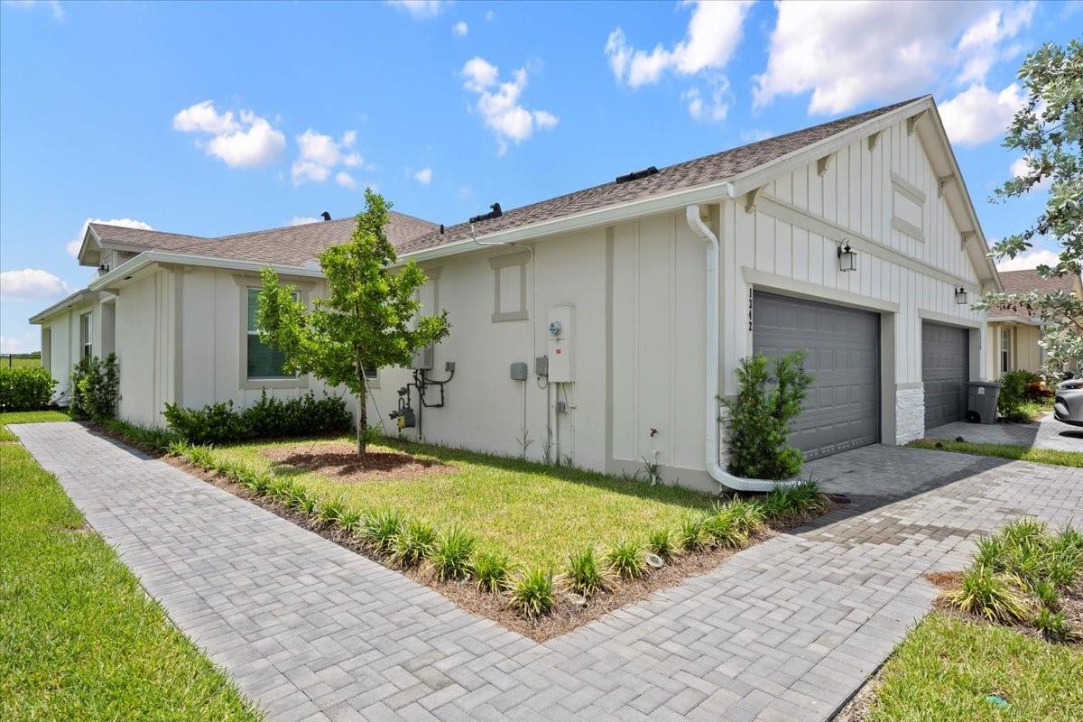 Experience living in a modern three bedroom two bathroom luxury home in Arden. Built in 2024, CBS construction with impact windows, tankless water heater, and beautiful upgrades. This home offers the benefit of privacy by having no neighbors behind, and serene views of the community landscaping in front of the property. The house has a large paved driveway suitable for multiple vehicles, in addition to the two car garage. The community is situated in an area of top rated schools, with a brand new elementary school nearby. Arden has countless amenities, which include a gorgeous clubhouse, resort style swimming pools, gym facility, kayaks and pickleball. Organically grown vegetables, fruit and herbs are available to residents in the community's five acre farm.