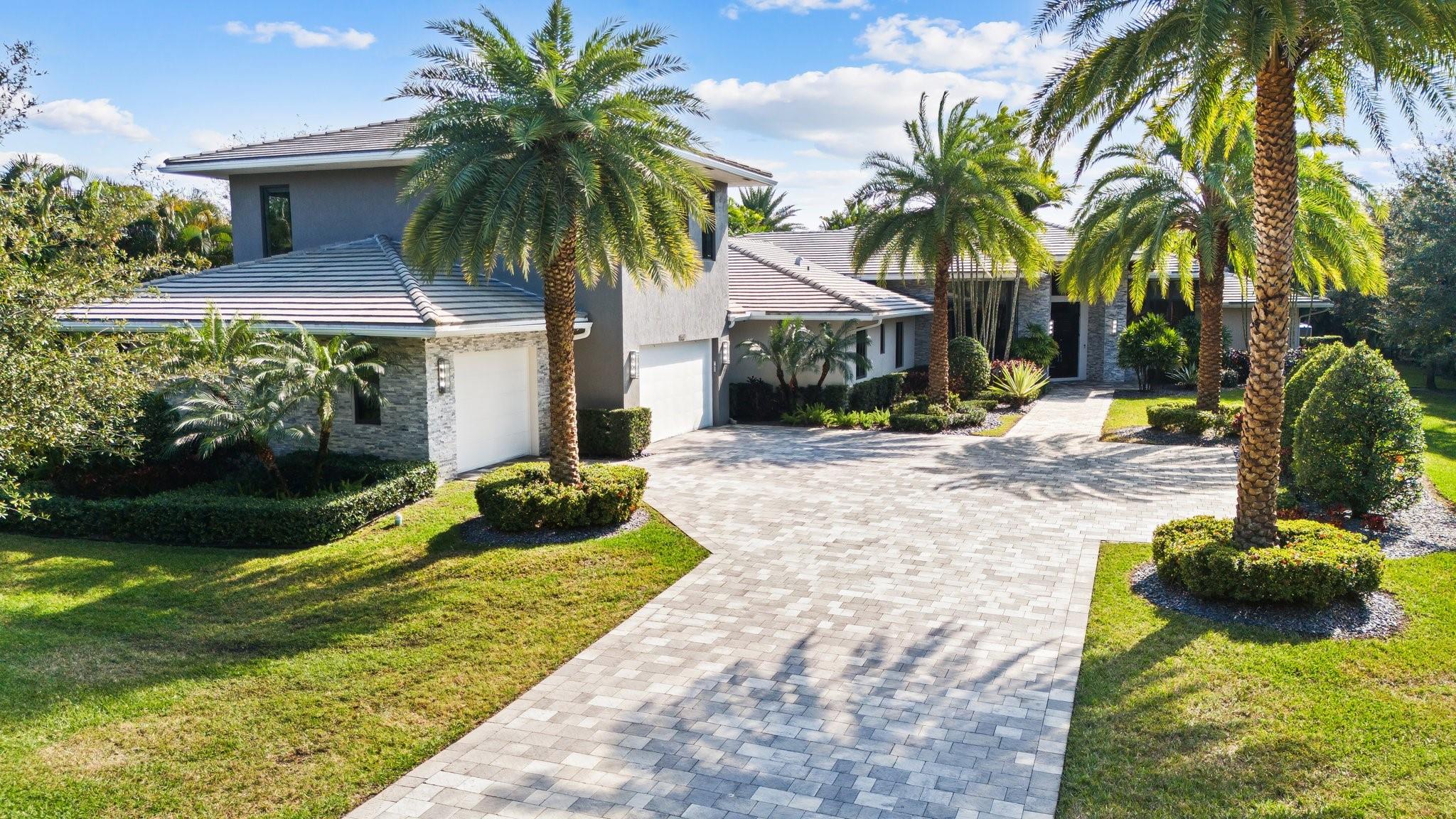 Welcome to Heritage Estates! Located in Plantation Acres, this stunning custom home, crafted by the renowned Brookman Fels, offers an unparalleled blend of luxury and comfort. Nestled on an expansive lot, this property provides ample space for both relaxation and entertainment with five bedrooms, office/library and large game/opportunity room plus 6.5 bathrooms. The gourmet kitchen is a chef's dream, featuring stainless steel appliances, quartz countertops, gas stove, double oven, and a spacious island. Outside, the private fenced yard is a true oasis with a summer kitchen, saltwater heated pool and hot tub, and sound system. The open floor plan seamlessly connects the living areas, creating an inviting atmosphere perfect for all to enjoy this Plantation gem!